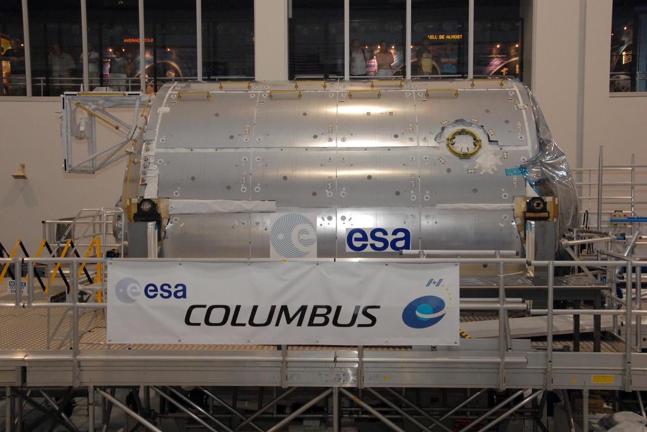 KENNEDY SPACE CENTER, FLA. -- In the Space Station Processing Facility at NASA's Kennedy Space Center, the Columbus Laboratory is positioned on a stand where it is being displayed to the media at a special showing.  Columbus is the European Space Agency 's largest single contribution to the International Space Station.  The laboratory module will expand the research facilities of the station, providing crew members and scientists around the world the ability to conduct a variety of life, physical and materials science experiments. The module is approximately 23 feet long and 15 feet wide, allowing it to hold 10 large racks of experiments. Columbus is scheduled to be transferred to Launch Pad 39A in early November, in preparation for its journey to the station. Columbus will fly aboard space shuttle Atlantis on the STS-122 mission, targeted for launch Dec. 6.  Photo credit: NASA/George Shelton