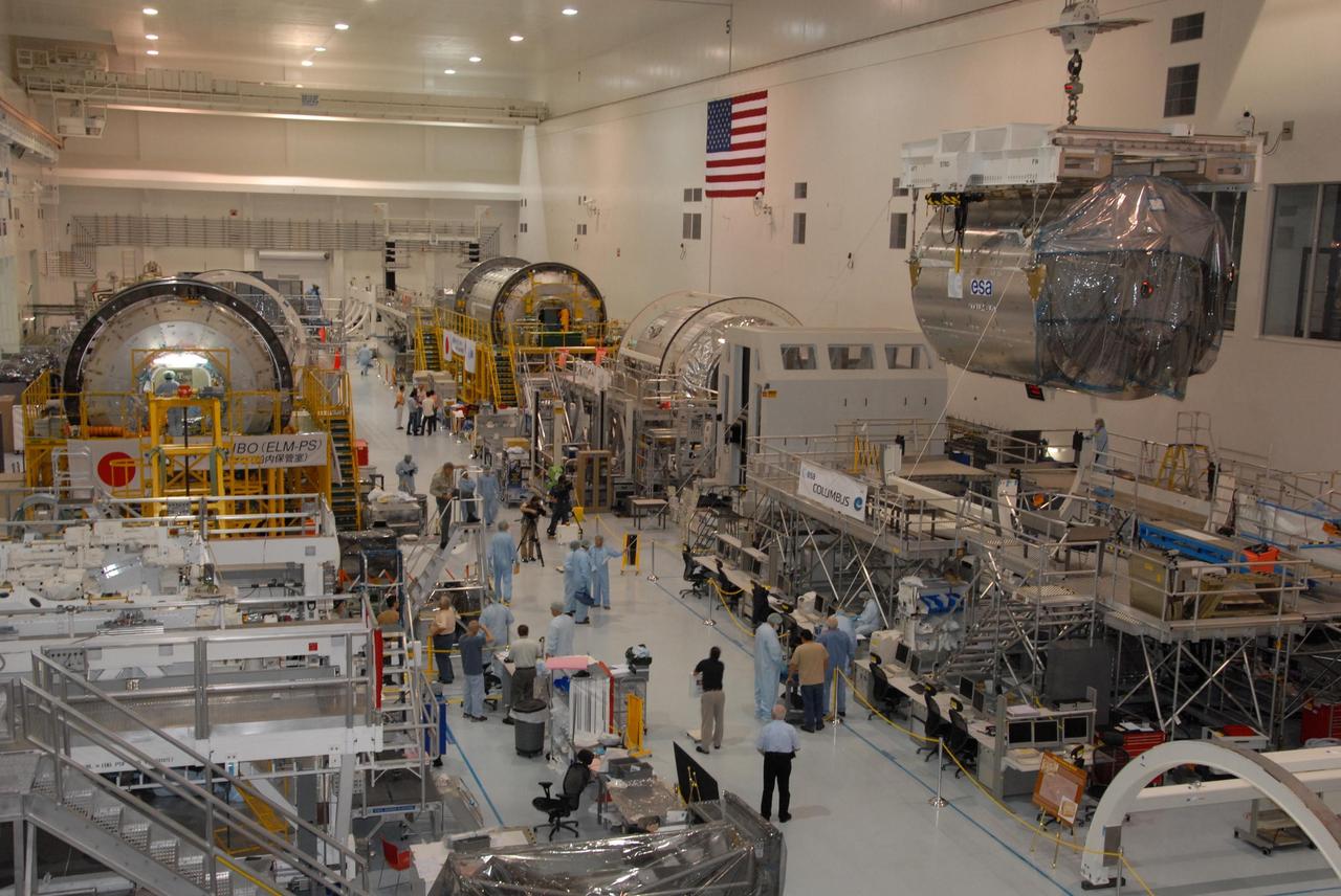 KENNEDY SPACE CENTER, FLA. -- In the Space Station Processing Facility at NASA's Kennedy Space Center, an overhead crane lifts the Columbus Laboratory module away from its stand.  The module is being moved to a weigh station before transfer to the payload canister.  The European Space Agency 's largest single contribution to the International Space Station, Columbus will expand the research facilities of the station, providing crew members and scientists around the world the ability to conduct a variety of life, physical and materials science experiments. The module is approximately 23 feet long and 15 feet wide, allowing it to hold 10 large racks of experiments. The module is scheduled to be transferred to Launch Pad 39A in early November, in preparation for its journey to the station. Columbus will fly aboard space shuttle Atlantis on the STS-122 mission, targeted for launch Dec. 6.  Photo credit: NASA/George Shelton