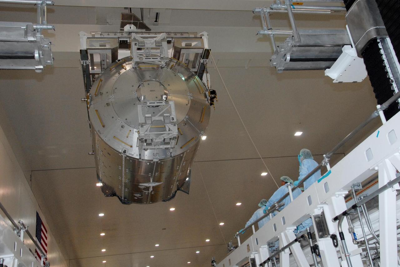 KENNEDY SPACE CENTER, FLA. -- In the Space Station Processing Facility at NASA's Kennedy Space Center, the Columbus Laboratory module is lowered toward a weigh station.  After being weighed, the module will be transferred to the payload canister. The European Space Agency 's largest single contribution to the International Space Station, Columbus will expand the research facilities of the station, providing crew members and scientists around the world the ability to conduct a variety of life, physical and materials science experiments. The module is approximately 23 feet long and 15 feet wide, allowing it to hold 10 large racks of experiments. The module is scheduled to be transferred to Launch Pad 39A in early November, in preparation for its journey to the station. Columbus will fly aboard space shuttle Atlantis on the STS-122 mission, targeted for launch Dec. 6.  Photo credit: NASA/George Shelton