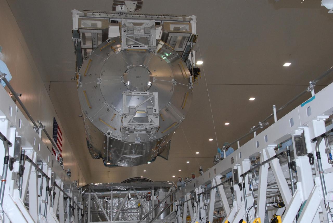 KENNEDY SPACE CENTER, FLA. -- In the Space Station Processing Facility at NASA's Kennedy Space Center, the Columbus Laboratory module is lowered toward a weigh station.  After being weighed, the module will be transferred to the payload canister. The European Space Agency 's largest single contribution to the International Space Station, Columbus will expand the research facilities of the station, providing crew members and scientists around the world the ability to conduct a variety of life, physical and materials science experiments. The module is approximately 23 feet long and 15 feet wide, allowing it to hold 10 large racks of experiments. The module is scheduled to be transferred to Launch Pad 39A in early November, in preparation for its journey to the station. Columbus will fly aboard space shuttle Atlantis on the STS-122 mission, targeted for launch Dec. 6.  Photo credit: NASA/George Shelton