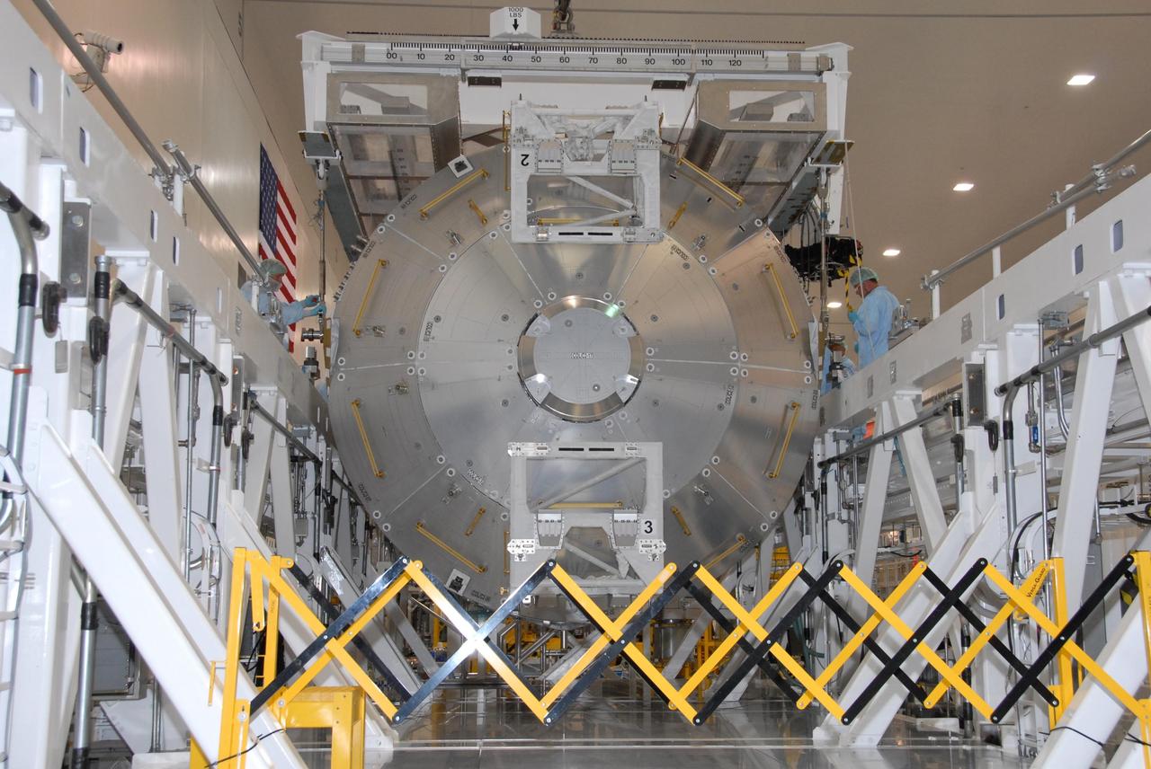 KENNEDY SPACE CENTER, FLA. -- In the Space Station Processing Facility at NASA's Kennedy Space Center, the Columbus Laboratory module is lowered onto a weigh station.  After being weighed, the module will be transferred to the payload canister. The European Space Agency 's largest single contribution to the International Space Station, Columbus will expand the research facilities of the station, providing crew members and scientists around the world the ability to conduct a variety of life, physical and materials science experiments. The module is approximately 23 feet long and 15 feet wide, allowing it to hold 10 large racks of experiments. The module is scheduled to be transferred to Launch Pad 39A in early November, in preparation for its journey to the station. Columbus will fly aboard space shuttle Atlantis on the STS-122 mission, targeted for launch Dec. 6.  Photo credit: NASA/George Shelton