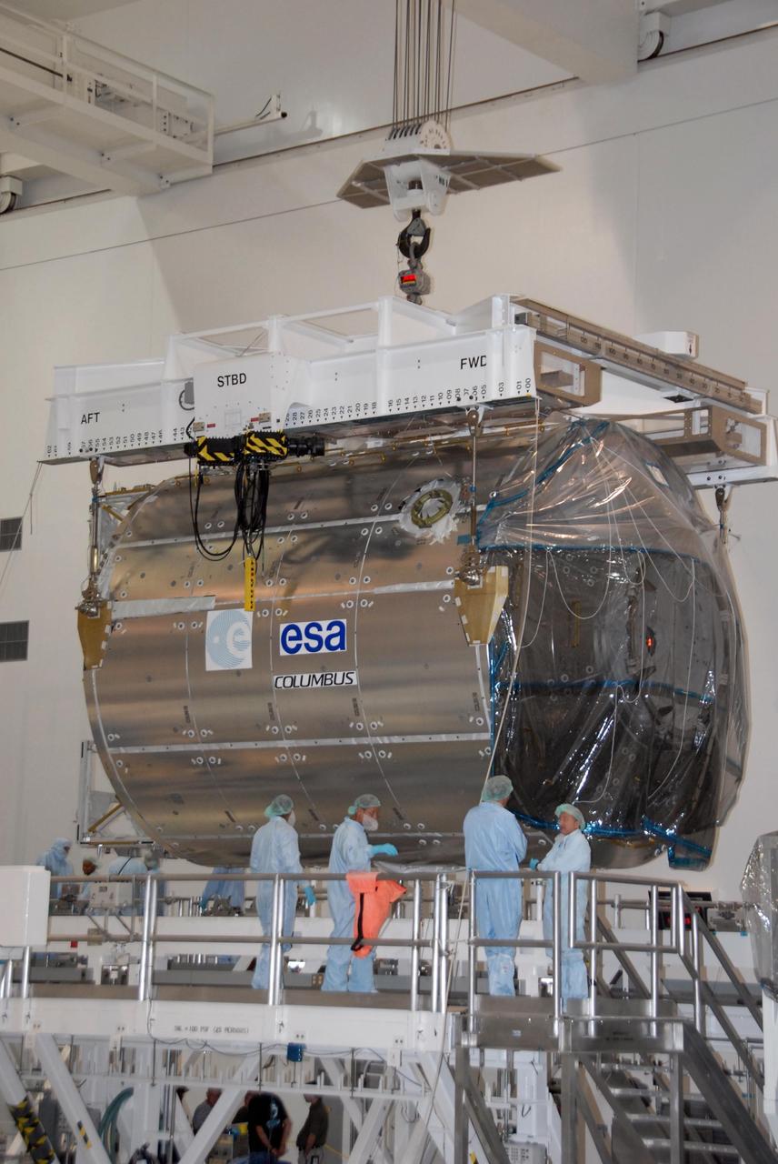 KENNEDY SPACE CENTER, FLA. -- In the Space Station Processing Facility at NASA's Kennedy Space Center, the Columbus Laboratory module is lifted for its transfer to a payload canister.  The canister will transport the module and other payloads to Launch Pad 39A in preparation for its journey to the International Space Station. The European Space Agency 's largest single contribution to the International Space Station, Columbus will expand the research facilities of the station, providing crew members and scientists around the world the ability to conduct a variety of life, physical and materials science experiments. The module is approximately 23 feet long and 15 feet wide, allowing it to hold 10 large racks of experiments. The module is scheduled to be transferred to Launch Pad 39A in early November, in preparation for its journey to the station. Columbus will fly aboard space shuttle Atlantis on the STS-122 mission, targeted for launch Dec. 6.  Photo credit: NASA/George Shelton