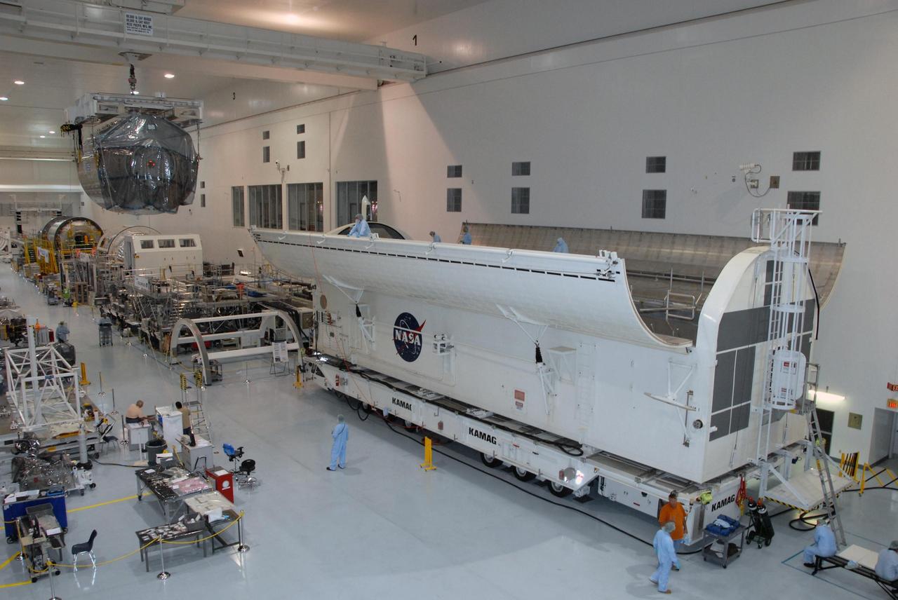 KENNEDY SPACE CENTER, FLA. -- In the Space Station Processing Facility at NASA's Kennedy Space Center, the Columbus Laboratory module moves across the facility to the waiting payload canister at right.  The canister will transport the module and other payloads to Launch Pad 39A in preparation for its journey to the International Space Station.   The European Space Agency 's largest single contribution to the International Space Station, Columbus will expand the research facilities of the station, providing crew members and scientists around the world the ability to conduct a variety of life, physical and materials science experiments. The module is approximately 23 feet long and 15 feet wide, allowing it to hold 10 large racks of experiments. The module is scheduled to be transferred to Launch Pad 39A in early November, in preparation for its journey to the station. Columbus will fly aboard space shuttle Atlantis on the STS-122 mission, targeted for launch Dec. 6.  Photo credit: NASA/George Shelton