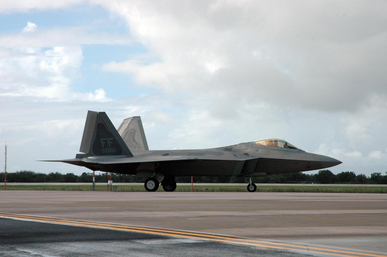 KENNEDY SPACE CENTER, FLA. -- A U.S. Air Force F-22 Raptor arrives at the Shuttle Landing Facility at NASA's Kennedy Space Center.  The plane is participating in the World Space Expo being held from Nov. 1 to Nov. 4 at the NASA Kennedy Space Center Visitor Complex.  Other aircraft joining in the salute include U.S. Air Force Thunderbirds Aerial Demonstration Squadron, U.S. Navy F-18 Super Hornets, the P-51 Mustang Heritage Flight and the U.S. Air Force 920th Rescue Wing, which was responsible for Mercury and Gemini capsule recovery.  The U.S. Army Golden Knights also will demonstrate precision skydiving.  The World Space Expo is an event to commemorate humanity's first 50 years in space while looking forward to returning people to the moon and exploring beyond. The expo will showcase various panels, presentations and educational programs. It also is a part of NASA's 50th anniversary celebrations, highlighting the 45th Anniversary of the Mercury Program celebration featuring original NASA astronauts John Glenn and Scott Carpenter and the Pioneering Women of Aerospace forum featuring Eileen Collins and other prominent female space veterans. The agency was founded Oct. 1, 1958.  Photo credit: NASA/Jack Pfaller