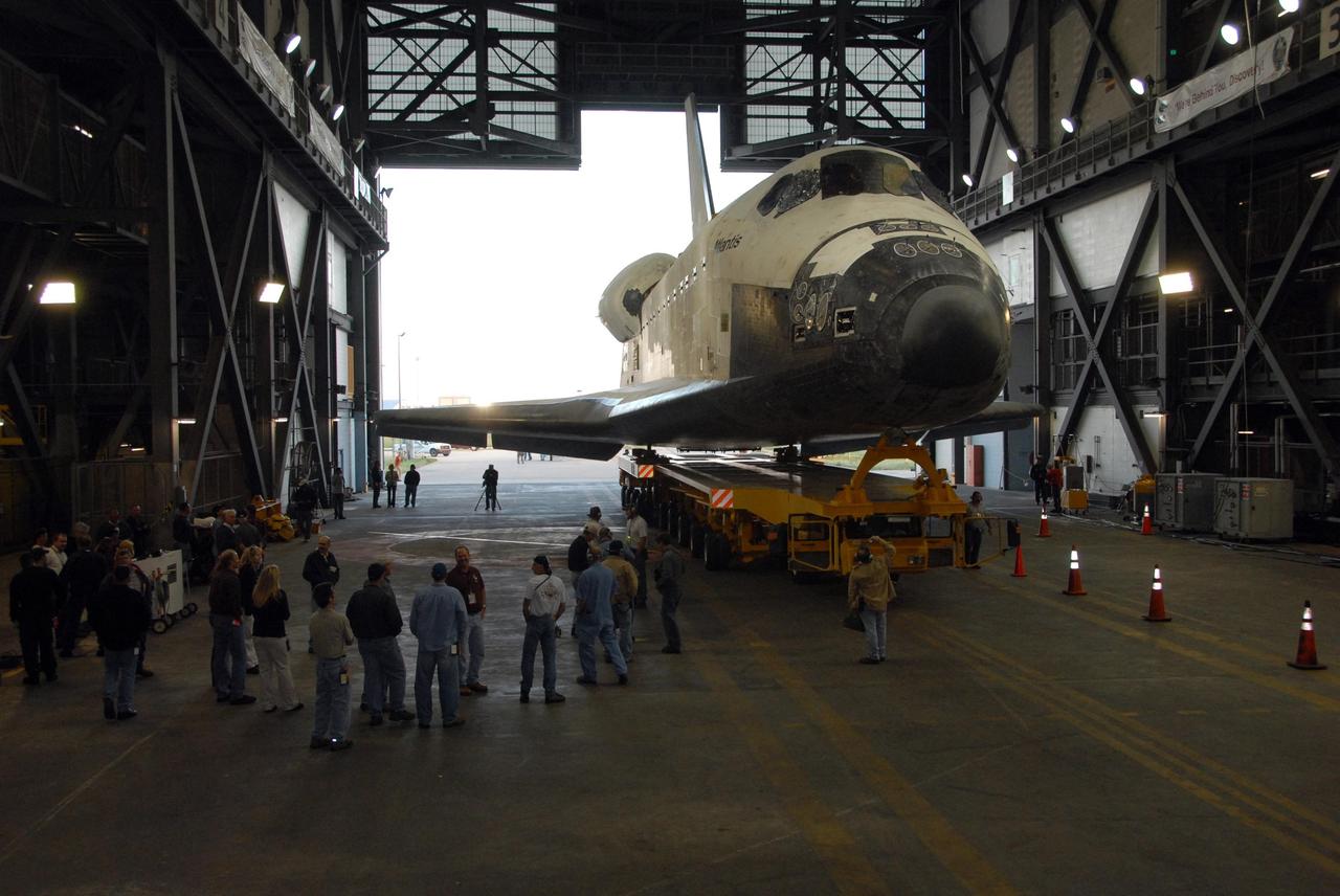 KENNEDY SPACE CENTER, FLA. -- Space shuttle Atlantis rolls into the transfer aisle of the Vehicle Assembly Building after its move from Orbiter Processing Facility bay 1.  Rollover from its processing bay began at 7:05 a.m. EDT. Atlantis arrived in the VAB's transfer aisle at 8:03 a.m. In the VAB, the shuttle will be lifted and mated with the external tank and solid rocket boosters designated for mission STS-122, already secured atop a mobile launcher platform.  On this mission, Atlantis will deliver the Columbus module to the International Space Station.  The European Space Agency's largest contribution to the station, Columbus is a multifunctional, pressurized laboratory that will be permanently attached to U.S. Node 2, called Harmony. The module is approximately 23 feet long and 15 feet wide, allowing it to hold 10 large racks of experiments.  The laboratory will expand the research facilities aboard the station, providing crew members and scientists from around the world the ability to conduct a variety of experiments in the physical, materials and life sciences.  Mission STS-122 is targeted for launch on Dec. 6.  Photo credit: NASA/George Shelton