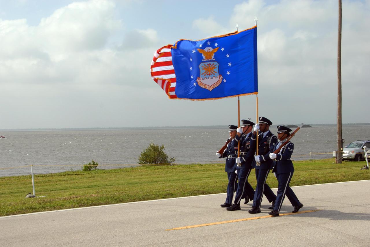 KENNEDY SPACE CENTER, FLA. -- During a rehearsal for the World Space Expo Aerial Salute at NASA's Kennedy Space Center, an honor guard from Patrick Air Force Base marches along the NASA Causeway. Commemorating humanity's first 50 years in space while looking forward to returning people to the moon and exploring beyond, the expo will showcase various panels, presentations and educational programs, as well as the air show.  Participating in the air show are the U.S. Air Force Thunderbirds, U.S. Air Force F-22 Raptor, U.S. Navy F-18 Super Hornet, U.S. Air Force F-15 Eagle, the P-51 Mustang Heritage Flight, and the U.S. Air Force 920th Rescue Wing, which was responsible for Mercury and Gemini capsule recovery. The U.S. Army Golden Knights will also demonstrate precision skydiving. Photo credit: NASA/George Shelton.