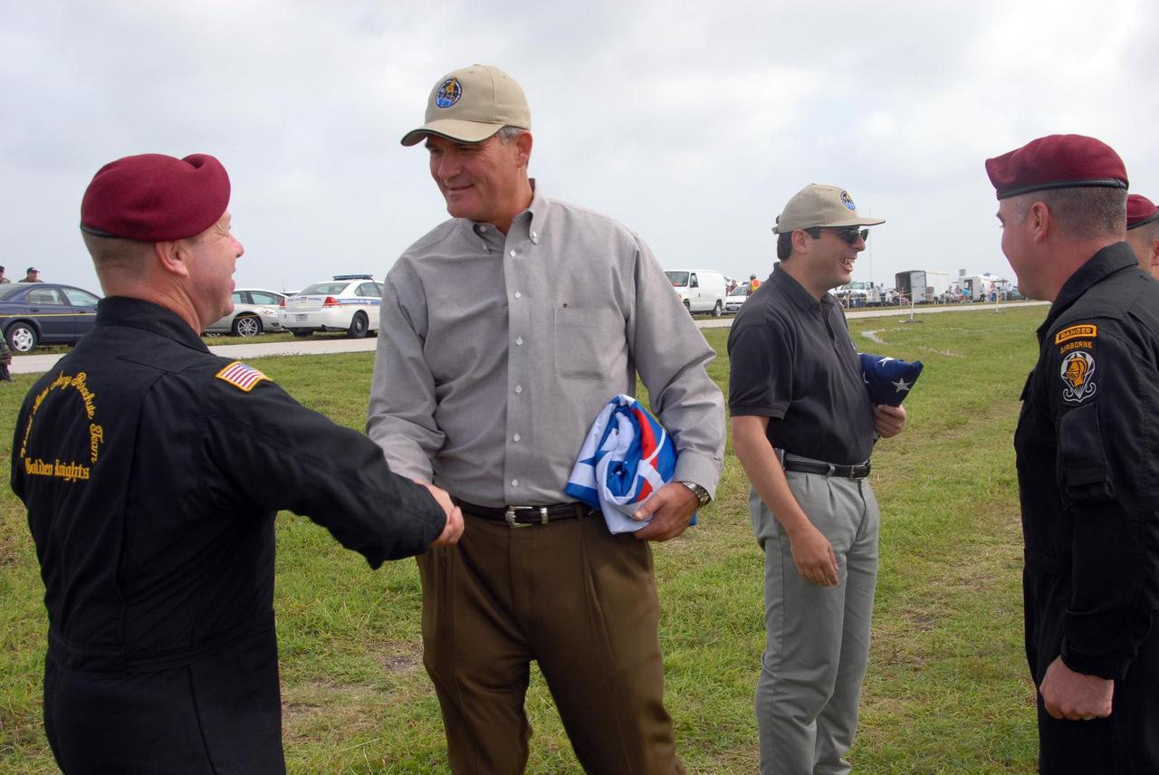 KENNEDY SPACE CENTER, FLA. -- During a rehearsal for the World Space Expo Aerial Salute at NASA's Kennedy Space Center, Center Director Bill Parsons (second from left) greets members of the U.S. Army Golden Knights who will demonstrate precision skydiving.  Commemorating humanity's first 50 years in space while looking forward to returning people to the moon and exploring beyond, the expo will showcase various panels, presentations and educational programs, as well as the air show.  Participating in the air show are the U.S. Air Force Thunderbirds, U.S. Air Force F-22 Raptor, U.S. Navy F-18 Super Hornet, U.S. Air Force F-15 Eagle, the P-51 Mustang Heritage Flight, and the U.S. Air Force 920th Rescue Wing, which was responsible for Mercury and Gemini capsule recovery. The U.S. Army Golden Knights will also demonstrate precision skydiving. Photo credit: NASA/George Shelton.