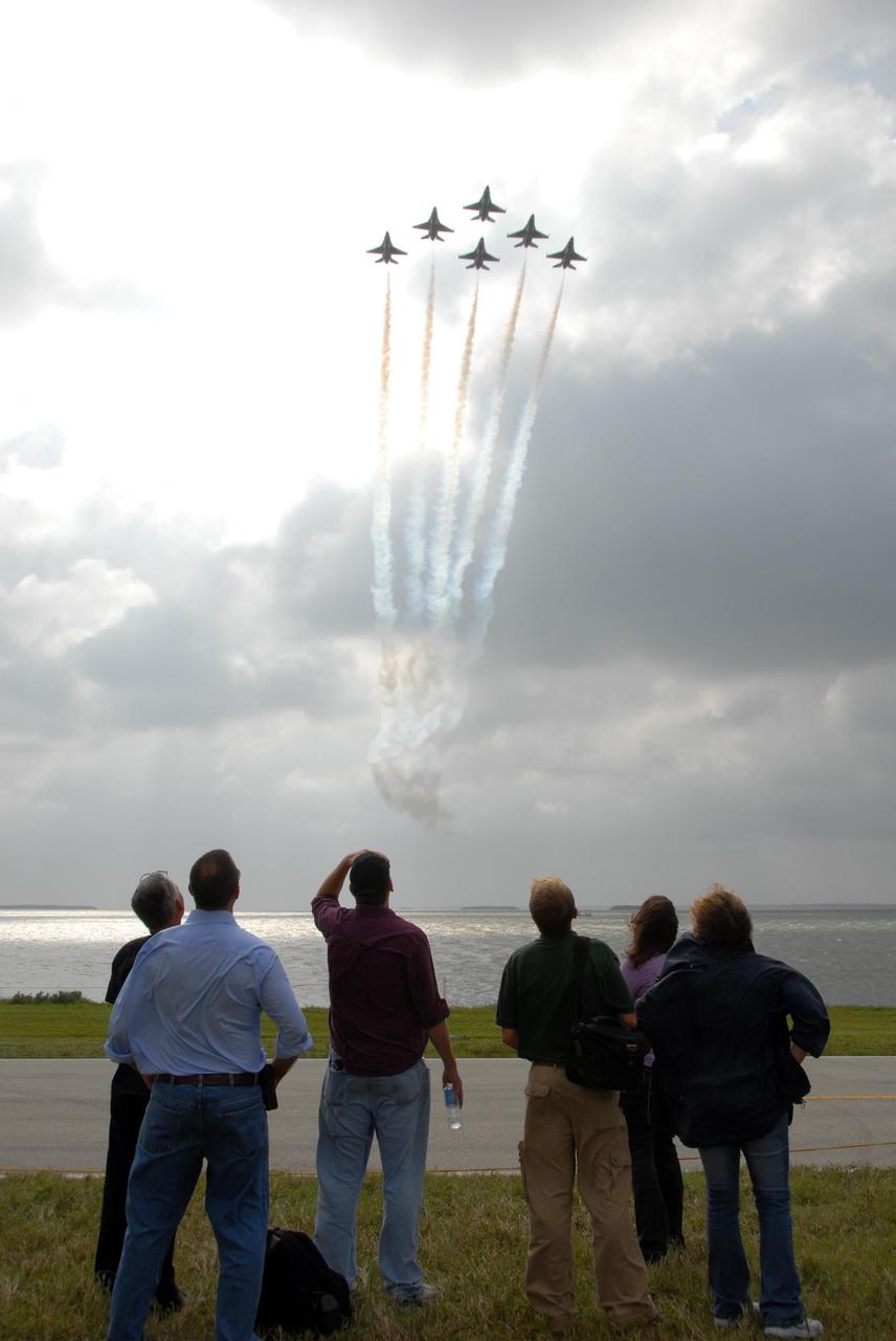 KENNEDY SPACE CENTER, FLA. -- Visitors gather along the NASA Causeway to watch the U.S. Air Force Thunderbirds practicing for the World Space Expo Aerial Salute at NASA's Kennedy Space Center.  Commemorating humanity's first 50 years in space while looking forward to returning people to the moon and exploring beyond, the expo will showcase various panels, presentations and educational programs, as well as the air show.  Participating in the air show are the U.S. Air Force Thunderbirds, U.S. Air Force F-22 Raptor, U.S. Navy F-18 Super Hornet, U.S. Air Force F-15 Eagle, the P-51 Mustang Heritage Flight, and the U.S. Air Force 920th Rescue Wing, which was responsible for Mercury and Gemini capsule recovery. The U.S. Army Golden Knights will also demonstrate precision skydiving. Photo credit: NASA/George Shelton.