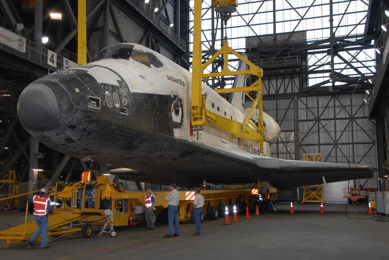 KENNEDY SPACE CENTER, FLA. — In the transfer aisle of the Vehicle Assembly Building at NASA's Kennedy Space Center, space shuttle Atlantis is fitted with a sling to raise it off its transporter into a vertical position. Atlantis will be lifted into high bay 3 and mated with the external tank and solid rocket boosters designated for mission STS-122, already secured atop a mobile launcher platform. On this mission, Atlantis will deliver the Columbus module to the International Space Station. The European Space Agency's largest contribution to the station, Columbus is a multifunctional, pressurized laboratory that will be permanently attached to U.S. Node 2, called Harmony. The module is approximately 23 feet long and 15 feet wide, allowing it to hold 10 large racks of experiments. The laboratory will expand the research facilities aboard the station, providing crew members and scientists from around the world the ability to conduct a variety of experiments in the physical, materials and life sciences. Mission STS-122 is targeted for launch on Dec. 6. Photo credit: NASA/George Shelton