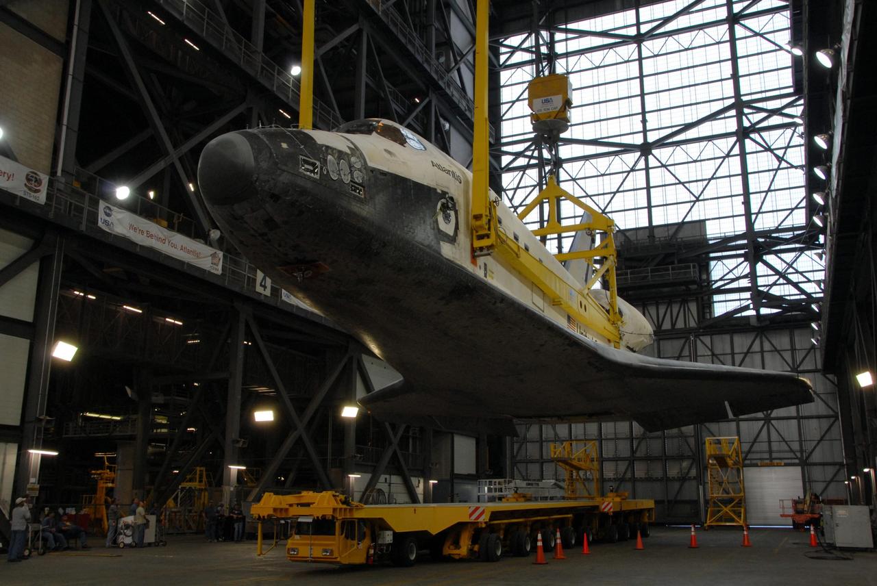 KENNEDY SPACE CENTER, FLA. — In the transfer aisle of the Vehicle Assembly Building at NASA's Kennedy Space Center, space shuttle Atlantis is raised off its transporter. After raised to a vertical position, Atlantis will be lifted into high bay 3 and mated with the external tank and solid rocket boosters designated for mission STS-122, already secured atop a mobile launcher platform. On this mission, Atlantis will deliver the Columbus module to the International Space Station. The European Space Agency's largest contribution to the station, Columbus is a multifunctional, pressurized laboratory that will be permanently attached to U.S. Node 2, called Harmony. The module is approximately 23 feet long and 15 feet wide, allowing it to hold 10 large racks of experiments. The laboratory will expand the research facilities aboard the station, providing crew members and scientists from around the world the ability to conduct a variety of experiments in the physical, materials and life sciences. Mission STS-122 is targeted for launch on Dec. 6. Photo credit: NASA/George Shelton