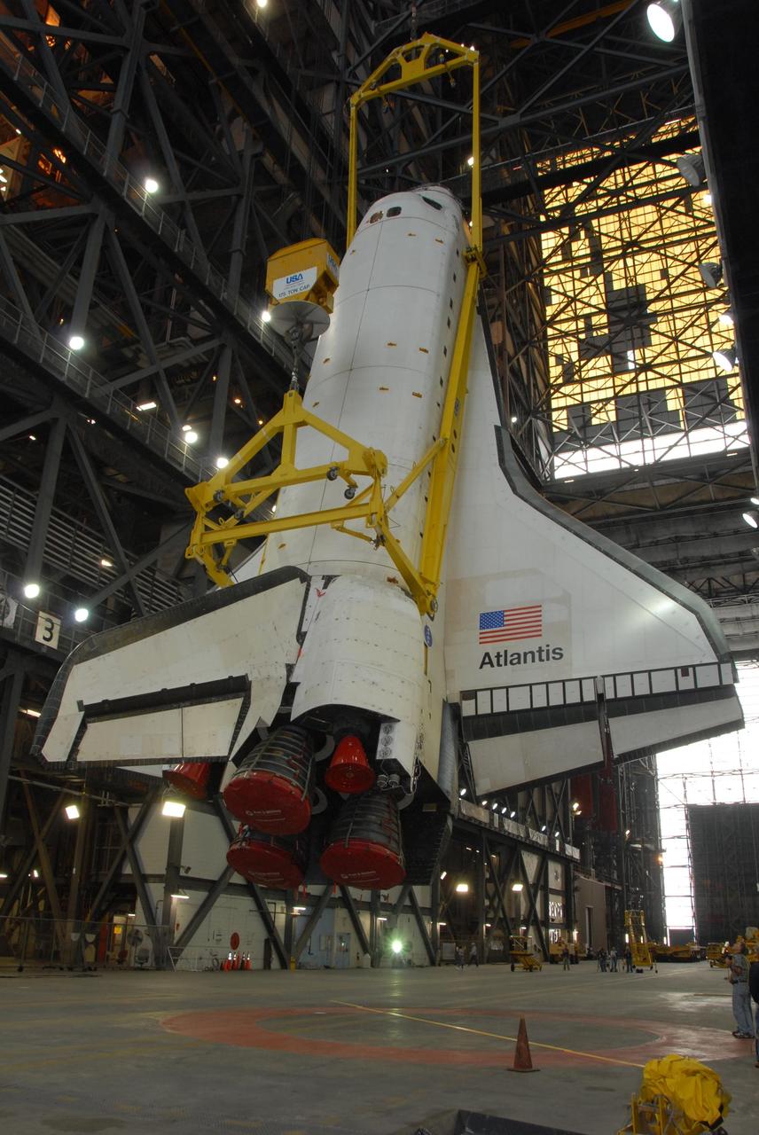 KENNEDY SPACE CENTER, FLA. — In the transfer aisle of the Vehicle Assembly Building at NASA's Kennedy Space Center, space shuttle Atlantis is raised to a nearly vertical position. Atlantis will next be lifted into high bay 3 and mated with the external tank and solid rocket boosters designated for mission STS-122, already secured atop a mobile launcher platform. On this mission, Atlantis will deliver the Columbus module to the International Space Station. The European Space Agency's largest contribution to the station, Columbus is a multifunctional, pressurized laboratory that will be permanently attached to U.S. Node 2, called Harmony. The module is approximately 23 feet long and 15 feet wide, allowing it to hold 10 large racks of experiments. The laboratory will expand the research facilities aboard the station, providing crew members and scientists from around the world the ability to conduct a variety of experiments in the physical, materials and life sciences. Mission STS-122 is targeted for launch on Dec. 6. Photo credit: NASA/George Shelton