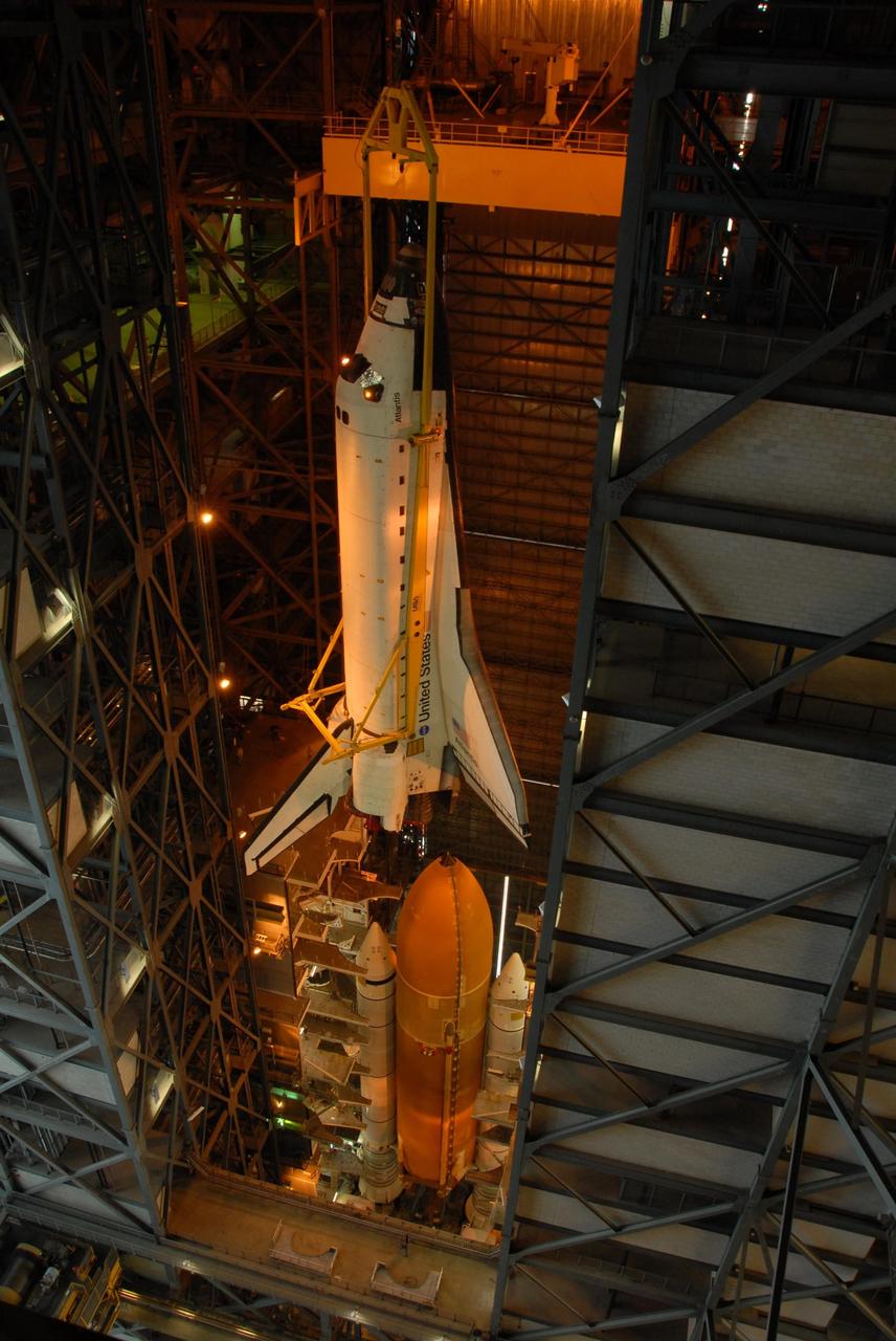 KENNEDY SPACE CENTER, FLA. -- In high bay 3 of the Vehicle Assembly Building at NASA's Kennedy Space Center, space shuttle Atlantis is lowered toward the external tank and solid rocket boosters waiting below, already secured atop the mobile launcher platform.  On this mission, Atlantis will deliver the Columbus module to the International Space Station. The European Space Agency's largest contribution to the station, Columbus is a multifunctional, pressurized laboratory that will be permanently attached to U.S. Node 2, called Harmony. The module is approximately 23 feet long and 15 feet wide, allowing it to hold 10 large racks of experiments. The laboratory will expand the research facilities aboard the station, providing crew members and scientists from around the world the ability to conduct a variety of experiments in the physical, materials and life sciences. Mission STS-122 is targeted for launch on Dec. 6.  Photo credit: NASA/George Shelton