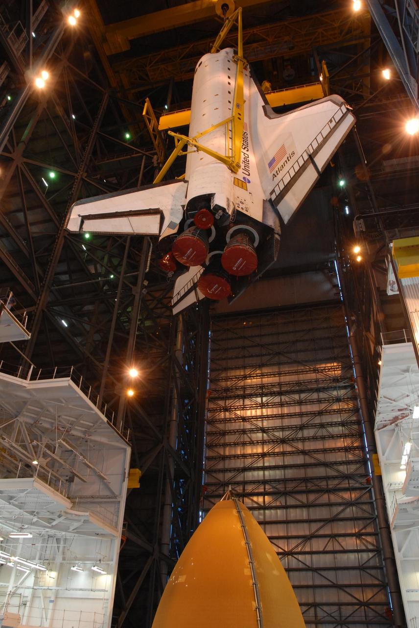 KENNEDY SPACE CENTER, FLA. -- In high bay 3 of the Vehicle Assembly Building at NASA's Kennedy Space Center, space shuttle Atlantis is lowered toward the external tank (seen at the bottom) and solid rocket boosters waiting below, already secured atop the mobile launcher platform. On this mission, Atlantis will deliver the Columbus module to the International Space Station. The European Space Agency's largest contribution to the station, Columbus is a multifunctional, pressurized laboratory that will be permanently attached to U.S. Node 2, called Harmony. The module is approximately 23 feet long and 15 feet wide, allowing it to hold 10 large racks of experiments. The laboratory will expand the research facilities aboard the station, providing crew members and scientists from around the world the ability to conduct a variety of experiments in the physical, materials and life sciences. Mission STS-122 is targeted for launch on Dec. 6. Photo credit: NASA/George Shelton