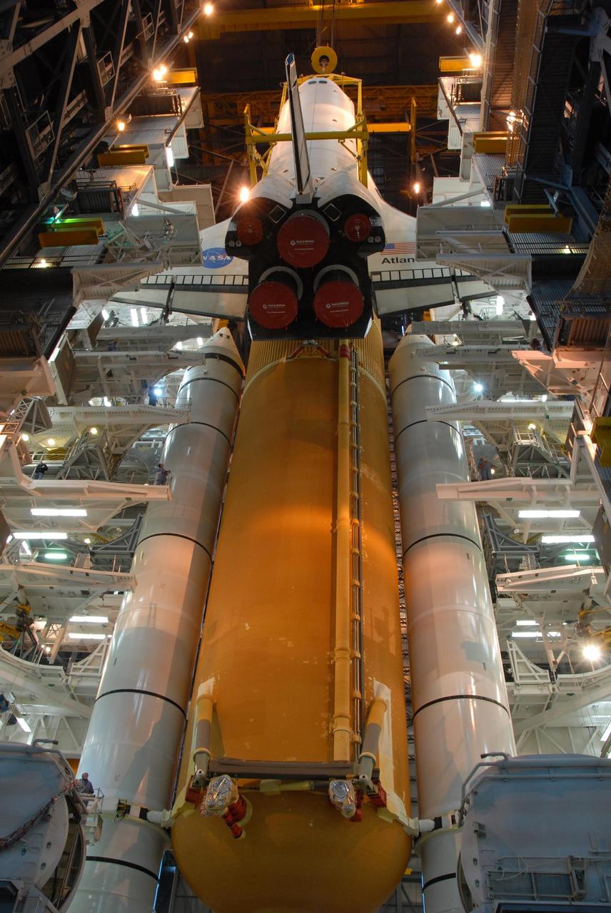 KENNEDY SPACE CENTER, FLA. -- In high bay 3 of the Vehicle Assembly Building at NASA's Kennedy Space Center, space shuttle Atlantis is lowered alongside the external tank and solid rocket boosters waiting below, already secured atop the mobile launcher platform. On this mission, Atlantis will deliver the Columbus module to the International Space Station. The European Space Agency's largest contribution to the station, Columbus is a multifunctional, pressurized laboratory that will be permanently attached to U.S. Node 2, called Harmony. The module is approximately 23 feet long and 15 feet wide, allowing it to hold 10 large racks of experiments. The laboratory will expand the research facilities aboard the station, providing crew members and scientists from around the world the ability to conduct a variety of experiments in the physical, materials and life sciences. Mission STS-122 is targeted for launch on Dec. 6. Photo credit: NASA/George Shelton