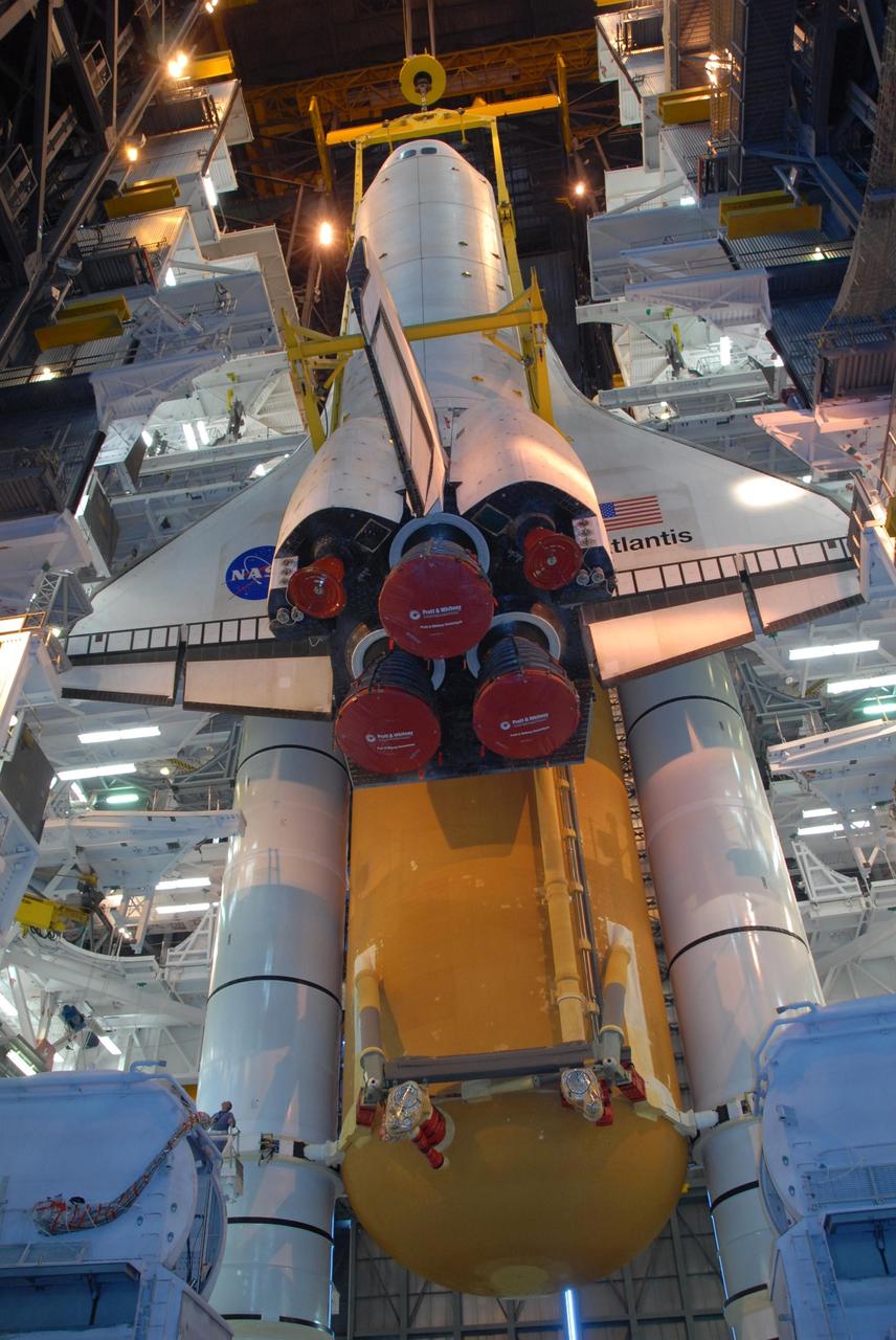 KENNEDY SPACE CENTER, FLA. -- In high bay 3 of the Vehicle Assembly Building at NASA's Kennedy Space Center, space shuttle Atlantis is lowered alongside the external tank and solid rocket boosters waiting below, already secured atop the mobile launcher platform. On this mission, Atlantis will deliver the Columbus module to the International Space Station. The European Space Agency's largest contribution to the station, Columbus is a multifunctional, pressurized laboratory that will be permanently attached to U.S. Node 2, called Harmony. The module is approximately 23 feet long and 15 feet wide, allowing it to hold 10 large racks of experiments. The laboratory will expand the research facilities aboard the station, providing crew members and scientists from around the world the ability to conduct a variety of experiments in the physical, materials and life sciences. Mission STS-122 is targeted for launch on Dec. 6. Photo credit: NASA/George Shelton