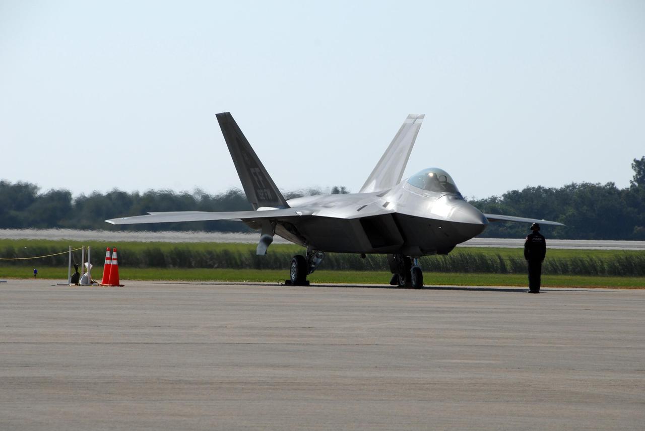 KENNEDY SPACE CENTER, FLA. —  This U.S. Air Force F-22 Raptor is part of an aerial salute for the World Space Expo at NASA's Kennedy Space Center Visitor Complex.  Other aircraft joining in the expo salute include the U.S. Air Force Thunderbirds Demonstration Squadron, the U.S. Navy F-18 Super Hornets, the U.S. Air Force F-15 Eagle, P-51 Mustang Heritage Flight, the U.S. Air Force 920th Rescue Wing, which was responsible for Mercury and Gemini capsule recovery, and the U.S. Army Golden Knights demonstrating precision skydiving.  The World Space Expo Nov. 1-4 was an event commemorating humanity's first 50 years in space while looking forward to returning people to the moon and exploring beyond. The expo showcased various panels, presentations and educational programs. It also was a part of NASA's 50th anniversary celebrations, highlighting the 45th Anniversary of the Mercury Program celebration featuring original NASA astronauts John Glenn and Scott Carpenter and the Pioneering Women of Aerospace forum featuring Eileen Collins and other prominent female space veterans. The agency was founded Oct. 1, 1958.  Photo credit: NASA/George Shelton