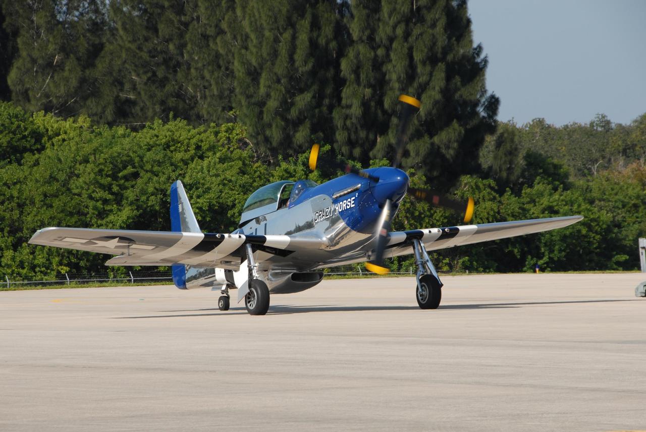 KENNEDY SPACE CENTER, FLA. — A P-51 Mustang, seen here on the Shuttle Landing Facility at NASA's Kennedy Space Center, is part of the World Space Expo aerial salute held at the Center's Visitor Complex.  Other aircraft joining in the expo salute include the U.S. Air Force Thunderbirds Demonstration Squadron, the U.S. Navy F-18 Super Hornets, U.S. Air Force F-22 Raptor,  U.S. Air Force F-15 Eagle, P-51 Mustang Heritage Flight, the U.S. Air Force 920th Rescue Wing, which was responsible for Mercury and Gemini capsule recovery, and the U.S. Army Golden Knights demonstrating precision skydiving. The World Space Expo Nov. 1-4 was an event commemorating humanity's first 50 years in space while looking forward to returning people to the moon and exploring beyond. The expo showcased various panels, presentations and educational programs. It also was a part of NASA's 50th anniversary celebrations, highlighting the 45th Anniversary of the Mercury Program celebration featuring original NASA astronauts John Glenn and Scott Carpenter and the Pioneering Women of Aerospace forum featuring Eileen Collins and other prominent female space veterans. The agency was founded Oct. 1, 1958.  Photo credit: NASA/George Shelton