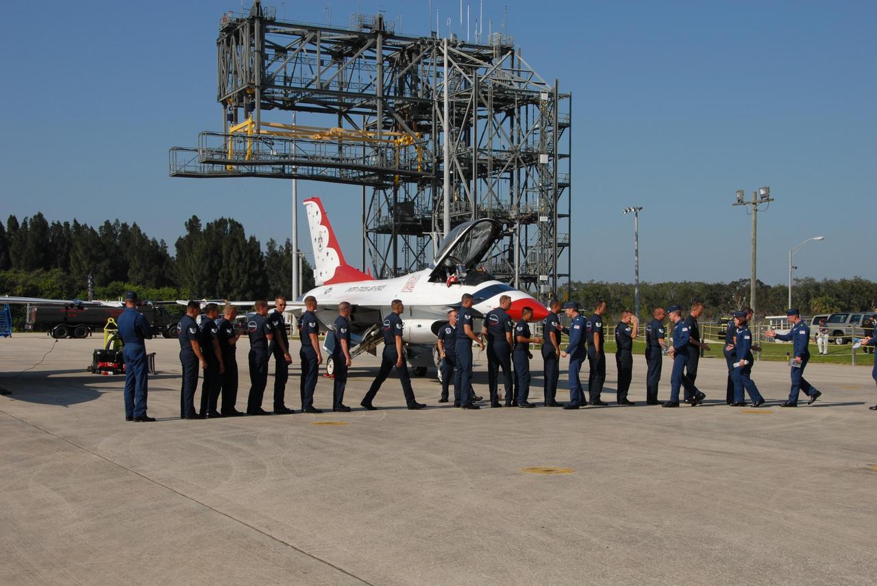 KENNEDY SPACE CENTER, FLA. — At NASA's Kennedy Space Center Shuttle Landing Facility, the air crew for the U.S. Air Force Thunderbirds Demonstration Squadron line up at left for a walkdown with the pilots, at right.  The squadron is part of an aerial salute for the World Space Expo held at the center's Visitor Complex.  Other aircraft joining in the expo salute include the U.S. Navy F-18 Super Hornets, U.S. Air Force F-22 Raptor,  U.S. Air Force F-15 Eagle, P-51 Mustang Heritage Flight, the U.S. Air Force 920th Rescue Wing, which was responsible for Mercury and Gemini capsule recovery, and the U.S. Army Golden Knights demonstrating precision skydiving. The World Space Expo Nov. 1-4 was an event commemorating humanity's first 50 years in space while looking forward to returning people to the moon and exploring beyond. The expo showcased various panels, presentations and educational programs. It also was a part of NASA's 50th anniversary celebrations, highlighting the 45th Anniversary of the Mercury Program celebration featuring original NASA astronauts John Glenn and Scott Carpenter and the Pioneering Women of Aerospace forum featuring Eileen Collins and other prominent female space veterans. The agency was founded Oct. 1, 1958.  Photo credit: NASA/George Shelton