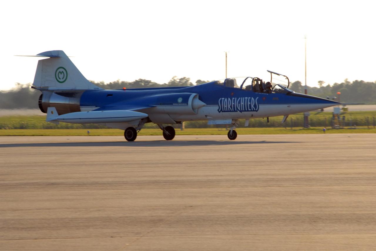 KENNEDY SPACE CENTER, FLA. — One of the Starfighters F-104 Demo Team pays a visit to NASA's Kennedy Space Center.  The Starfighters are taking part in an air show in Jacksonville, Fla., and took the time to pay tribute to the World Space Expo at the center.  The expo included an aerial salute featuring the U.S. Air Force Thunderbirds Demonstration Squadron, the U.S. Navy F-18 Super Hornets, U.S. Air Force F-22 Raptor,  U.S. Air Force F-15 Eagle, P-51 Mustang Heritage Flight, the U.S. Air Force 920th Rescue Wing, which was responsible for Mercury and Gemini capsule recovery, and the U.S. Army Golden Knights demonstrating precision skydiving.  The World Space Expo Nov. 1-4 was an event commemorating humanity's first 50 years in space while looking forward to returning people to the moon and exploring beyond. The expo showcased various panels, presentations and educational programs. It also was a part of NASA's 50th anniversary celebrations, highlighting the 45th Anniversary of the Mercury Program celebration featuring original NASA astronauts John Glenn and Scott Carpenter and the Pioneering Women of Aerospace forum featuring Eileen Collins and other prominent female space veterans. The agency was founded Oct. 1, 1958.  Photo credit: NASA/George Shelton