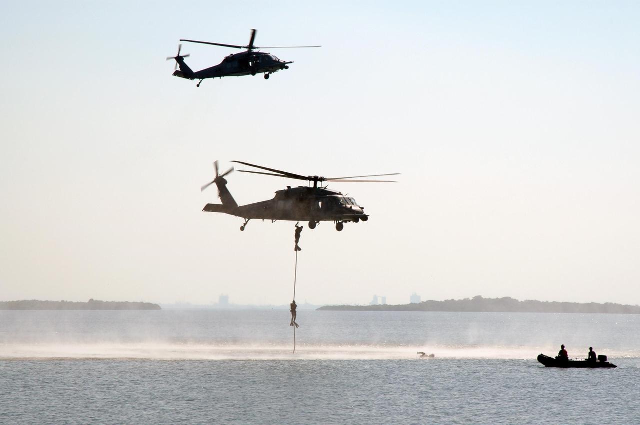 KENNEDY SPACE CENTER, FLA. --  In the water next to the NASA Causeway at NASA's Kennedy Space Center, part of the U.S. Air Force 920th Rescue Wing puts on a demonstration during the World Space Expo aerial salute.  This unit was responsible for Mercury and Gemini capsule recovery.  Other aircraft joining in the expo salute include the U.S. Air Force Thunderbirds Demonstration Squadron, the U.S. Navy F-18 Super Hornets, U.S. Air Force F-22 Raptor,  U.S. Air Force F-15 Eagle, P-51 Mustang Heritage Flight, and the U.S. Army Golden Knights demonstrating precision skydiving. The World Space Expo held Nov. 1-4 was an event commemorating humanity's first 50 years in space while looking forward to returning people to the moon and exploring beyond. The expo showcased various panels, presentations and educational programs. It also was a part of NASA's 50th anniversary celebrations, highlighting the 45th Anniversary of the Mercury Program celebration featuring original NASA astronauts John Glenn and Scott Carpenter and the Pioneering Women of Aerospace forum featuring Eileen Collins and other prominent female space veterans. The agency was founded Oct. 1, 1958.  Photo credit: NASA/Chris Chamberland