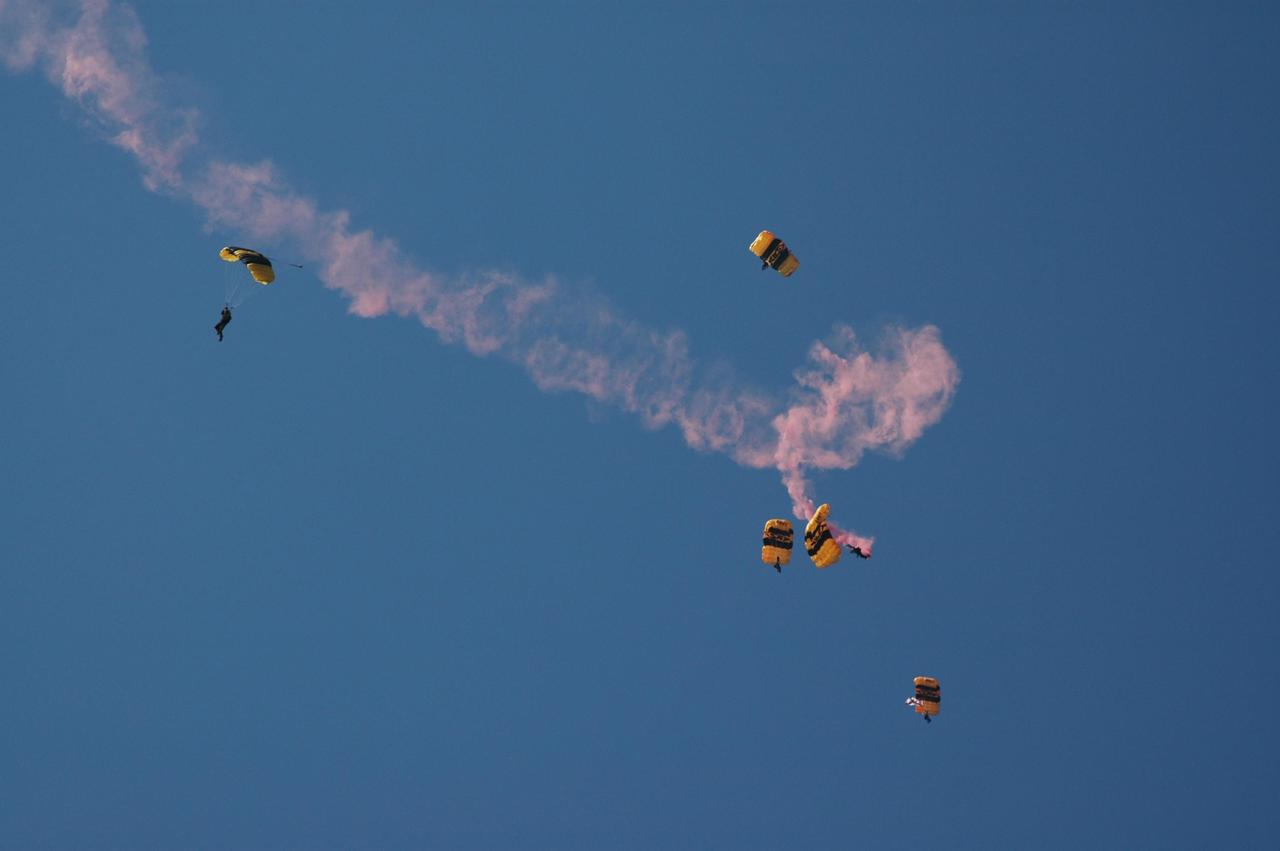 KENNEDY SPACE CENTER, FLA. --   The U.S. Army Golden Knights demonstrate precision skydiving as part of the World Space Expo aerial salute at NASA's Kennedy Space Center.  Other aircraft joining in the expo salute include the U.S. Air Force Thunderbirds Demonstration Squadron, the U.S. Navy F-18 Super Hornets, U.S. Air Force F-22 Raptor,  U.S. Air Force F-15 Eagle, P-51 Mustang Heritage Flight, and the U.S. Air Force 920th Rescue wing, which was responsible for Mercury and Gemini capsule recovery.  The World Space Expo held Nov. 1-4 was an event commemorating humanity's first 50 years in space while looking forward to returning people to the moon and exploring beyond. The expo showcased various panels, presentations and educational programs. It also was a part of NASA's 50th anniversary celebrations, highlighting the 45th Anniversary of the Mercury Program celebration featuring original NASA astronauts John Glenn and Scott Carpenter and the Pioneering Women of Aerospace forum featuring Eileen Collins and other prominent female space veterans. The agency was founded Oct. 1, 1958.  Photo credit: NASA/Chris Chamberland