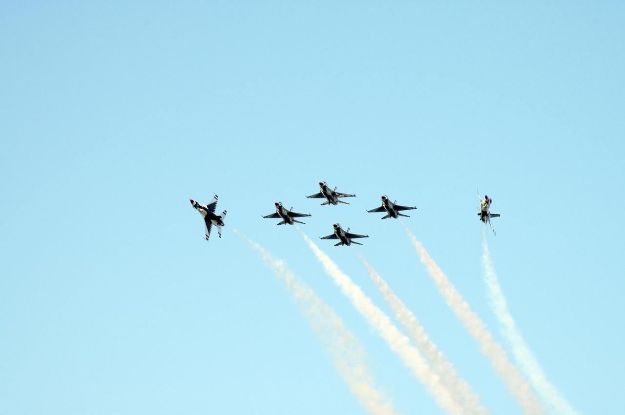KENNEDY SPACE CENTER, FLA. --  At NASA's Kennedy Space Center, the U.S. Air Force Thunderbirds Demonstration Squadron performs during the World Space Expo aerial salute.  Other aircraft joining in the expo salute include the U.S. Navy F-18 Super Hornets, U.S. Air Force F-22 Raptor, U.S. Air Force F-15 Eagle, P-51 Mustang Heritage Flight, U.S. Air Force 920th Rescue wing, which was responsible for Mercury and Gemini capsule recovery, and the U.S. Army Golden Knights demonstrating precision skydiving. The World Space Expo held Nov. 1-4 was an event commemorating humanity's first 50 years in space while looking forward to returning people to the moon and exploring beyond. The expo showcased various panels, presentations and educational programs. It also was a part of NASA's 50th anniversary celebrations, highlighting the 45th Anniversary of the Mercury Program celebration featuring original NASA astronauts John Glenn and Scott Carpenter and the Pioneering Women of Aerospace forum featuring Eileen Collins and other prominent female space veterans. The agency was founded Oct. 1, 1958.  Photo credit: NASA/Chris Chamberland