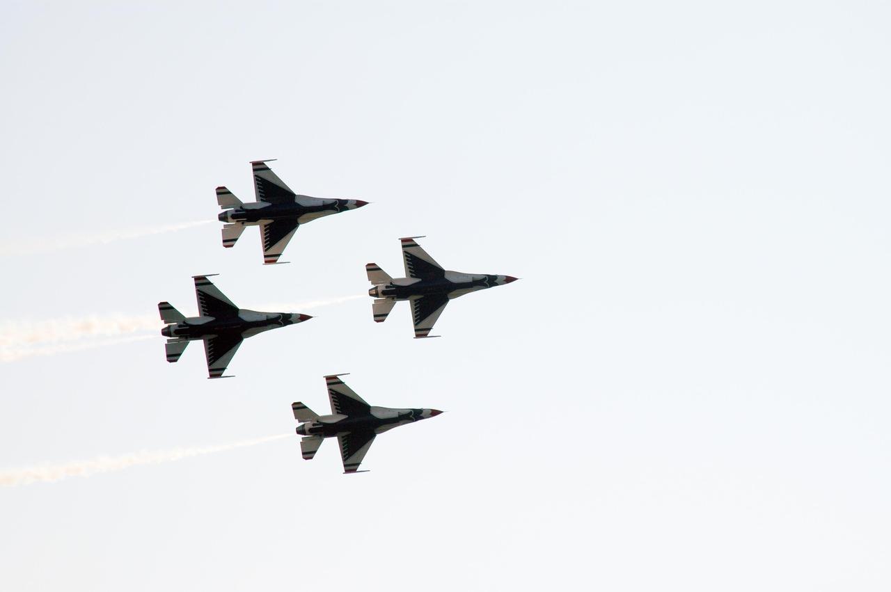 KENNEDY SPACE CENTER, FLA. --  At NASA's Kennedy Space Center, the U.S. Air Force Thunderbirds Demonstration Squadron performs during the World Space Expo aerial salute.  Other aircraft joining in the expo salute include the U.S. Navy F-18 Super Hornets, U.S. Air Force F-22 Raptor, U.S. Air Force F-15 Eagle, P-51 Mustang Heritage Flight, U.S. Air Force 920th Rescue wing, which was responsible for Mercury and Gemini capsule recovery, and the U.S. Army Golden Knights demonstrating precision skydiving. The World Space Expo held Nov. 1-4 was an event commemorating humanity's first 50 years in space while looking forward to returning people to the moon and exploring beyond. The expo showcased various panels, presentations and educational programs. It also was a part of NASA's 50th anniversary celebrations, highlighting the 45th Anniversary of the Mercury Program celebration featuring original NASA astronauts John Glenn and Scott Carpenter and the Pioneering Women of Aerospace forum featuring Eileen Collins and other prominent female space veterans. The agency was founded Oct. 1, 1958.  Photo credit: NASA/Chris Chamberland