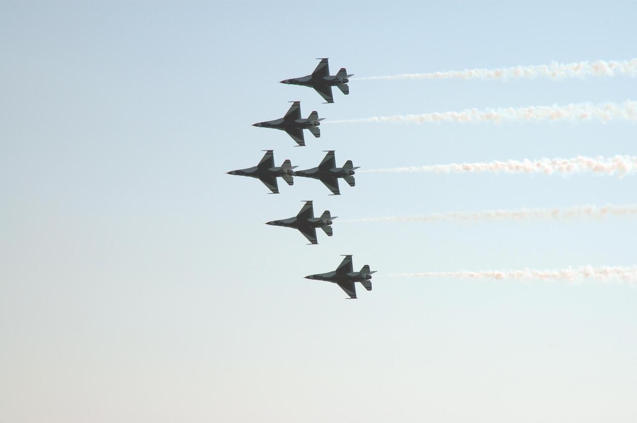 KENNEDY SPACE CENTER, FLA. --  At NASA's Kennedy Space Center, the U.S. Air Force Thunderbirds Demonstration Squadron performs during the World Space Expo aerial salute.  Other aircraft joining in the expo salute include the U.S. Navy F-18 Super Hornets, U.S. Air Force F-22 Raptor, U.S. Air Force F-15 Eagle, P-51 Mustang Heritage Flight, U.S. Air Force 920th Rescue wing, which was responsible for Mercury and Gemini capsule recovery, and the U.S. Army Golden Knights demonstrating precision skydiving. The World Space Expo held Nov. 1-4 was an event commemorating humanity's first 50 years in space while looking forward to returning people to the moon and exploring beyond. The expo showcased various panels, presentations and educational programs. It also was a part of NASA's 50th anniversary celebrations, highlighting the 45th Anniversary of the Mercury Program celebration featuring original NASA astronauts John Glenn and Scott Carpenter and the Pioneering Women of Aerospace forum featuring Eileen Collins and other prominent female space veterans. The agency was founded Oct. 1, 1958.  Photo credit: NASA/Chris Chamberland