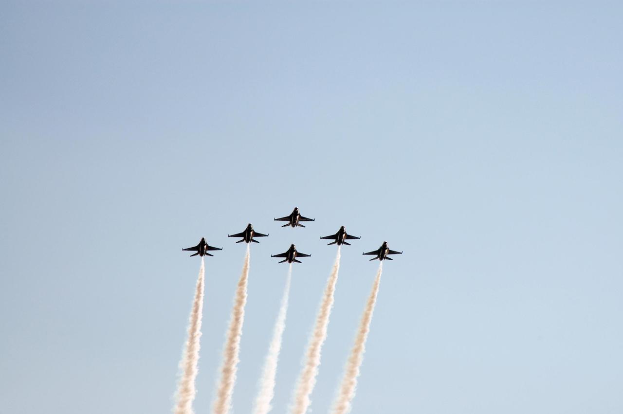 KENNEDY SPACE CENTER, FLA. --  At NASA's Kennedy Space Center, the U.S. Navy F-18 Super Hornets demonstrate their formation flying during the World Space Expo aerial salute.  Other aircraft joining in the expo salute include the U.S. Air Force Thunderbirds Demonstration Squadron, U.S. Air Force F-22 Raptor, U.S. Air Force F-15 Eagle, P-51 Mustang Heritage Flight, U.S. Air Force 920th Rescue wing, which was responsible for Mercury and Gemini capsule recovery, and the U.S. Army Golden Knights demonstrating precision skydiving. The World Space Expo held Nov. 1-4 was an event commemorating humanity's first 50 years in space while looking forward to returning people to the moon and exploring beyond. The expo showcased various panels, presentations and educational programs. It also was a part of NASA's 50th anniversary celebrations, highlighting the 45th Anniversary of the Mercury Program celebration featuring original NASA astronauts John Glenn and Scott Carpenter and the Pioneering Women of Aerospace forum featuring Eileen Collins and other prominent female space veterans. The agency was founded Oct. 1, 1958.  Photo credit: NASA/Chris Chamberland