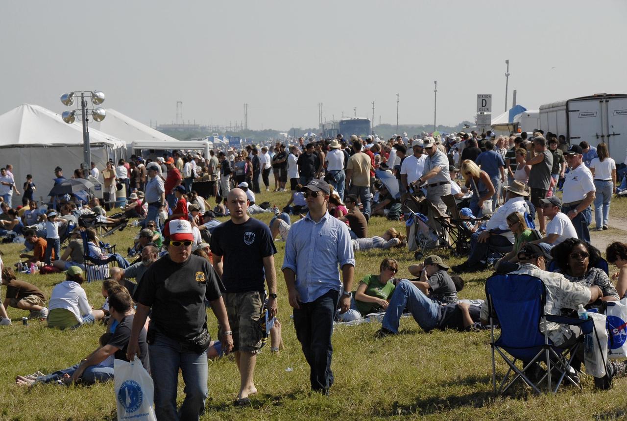 KENNEDY SPACE CENTER, FLA. --  Crowds fill the areas along NASA Causeway at NASA's Kennedy Space Center to watch the World Space Expo aerial salute.  Aircraft joining in the expo salute include the U.S. Air Force Thunderbirds Demonstration Squadron, the U.S. Navy F-18 Super Hornets, U.S. Air Force F-22 Raptor,  U.S. Air Force F-15 Eagle, P-51 Mustang Heritage Flight, the U.S. Air Force 920th Rescue Wing, which was responsible for Mercury and Gemini capsule recovery, and the U.S. Army Golden Knights precision skydivers. The World Space Expo held Nov. 1-4 was an event commemorating humanity's first 50 years in space while looking forward to returning people to the moon and exploring beyond. The expo showcased various panels, presentations and educational programs. It also was a part of NASA's 50th anniversary celebrations, highlighting the 45th Anniversary of the Mercury Program celebration featuring original NASA astronauts John Glenn and Scott Carpenter and the Pioneering Women of Aerospace forum featuring Eileen Collins and other prominent female space veterans. The agency was founded Oct. 1, 1958.   Photo credit: NASA/Kim Shiflett