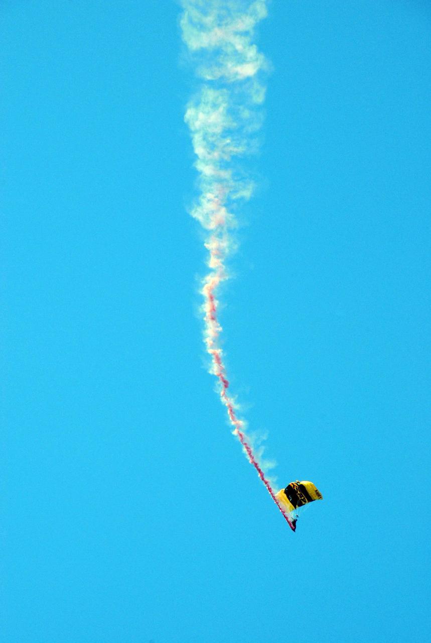 KENNEDY SPACE CENTER, FLA. --  A member of the U.S. Army Golden Knights demonstrates precision skydiving as part of the World Space Expo aerial salute at NASA's Kennedy Space Center.  Other aircraft joining in the expo salute include the U.S. Air Force Thunderbirds Demonstration Squadron, the U.S. Navy F-18 Super Hornets, U.S. Air Force F-22 Raptor,  U.S. Air Force F-15 Eagle, P-51 Mustang Heritage Flight, and the U.S. Air Force 920th Rescue Wing, which was responsible for Mercury and Gemini capsule recovery. The World Space Expo held Nov. 1-4 was an event commemorating humanity's first 50 years in space while looking forward to returning people to the moon and exploring beyond. The expo showcased various panels, presentations and educational programs. It also was a part of NASA's 50th anniversary celebrations, highlighting the 45th Anniversary of the Mercury Program celebration featuring original NASA astronauts John Glenn and Scott Carpenter and the Pioneering Women of Aerospace forum featuring Eileen Collins and other prominent female space veterans. The agency was founded Oct. 1, 1958.   Photo credit: NASA/Kim Shiflett