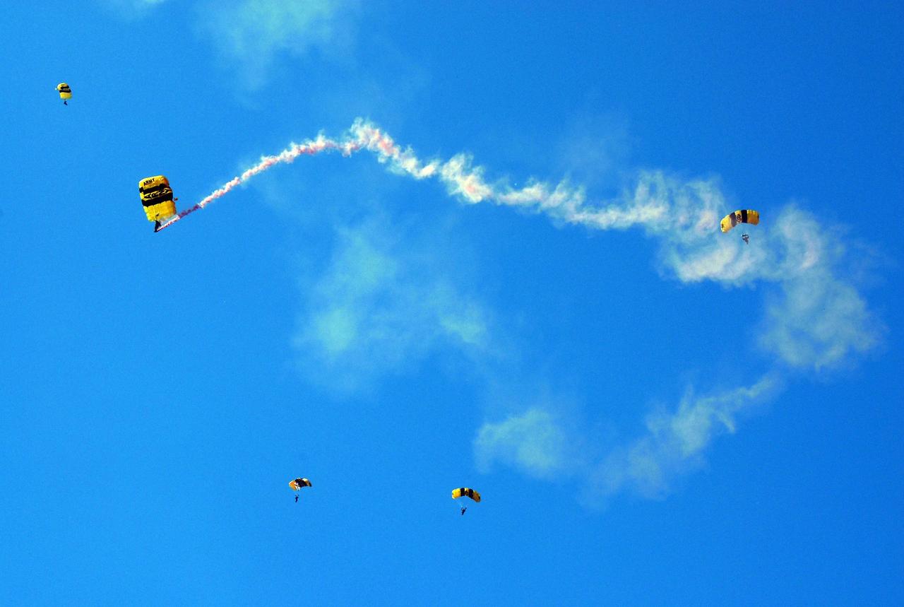 KENNEDY SPACE CENTER, FLA. --  The U.S. Army Golden Knights demonstrate precision skydiving as part of the World Space Expo aerial salute at NASA's Kennedy Space Center.  Other aircraft joining in the expo salute include the U.S. Air Force Thunderbirds Demonstration Squadron, the U.S. Navy F-18 Super Hornets, U.S. Air Force F-22 Raptor,  U.S. Air Force F-15 Eagle, P-51 Mustang Heritage Flight, and the U.S. Air Force 920th Rescue Wing, which was responsible for Mercury and Gemini capsule recovery. The World Space Expo held Nov. 1-4 was an event commemorating humanity's first 50 years in space while looking forward to returning people to the moon and exploring beyond. The expo showcased various panels, presentations and educational programs. It also was a part of NASA's 50th anniversary celebrations, highlighting the 45th Anniversary of the Mercury Program celebration featuring original NASA astronauts John Glenn and Scott Carpenter and the Pioneering Women of Aerospace forum featuring Eileen Collins and other prominent female space veterans. The agency was founded Oct. 1, 1958.   Photo credit: NASA/Kim Shiflett