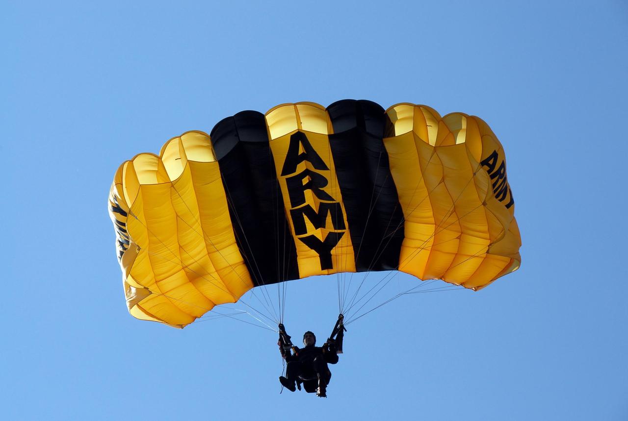 KENNEDY SPACE CENTER, FLA. --  A member of the U.S. Army Golden Knights demonstrates precision landing as part of the World Space Expo aerial salute at NASA's Kennedy Space Center.  Other aircraft joining in the expo salute include the U.S. Air Force Thunderbirds Demonstration Squadron, the U.S. Navy F-18 Super Hornets, U.S. Air Force F-22 Raptor,  U.S. Air Force F-15 Eagle, P-51 Mustang Heritage Flight, and the U.S. Air Force 920th Rescue Wing, which was responsible for Mercury and Gemini capsule recovery. The World Space Expo held Nov. 1-4 was an event commemorating humanity's first 50 years in space while looking forward to returning people to the moon and exploring beyond. The expo showcased various panels, presentations and educational programs. It also was a part of NASA's 50th anniversary celebrations, highlighting the 45th Anniversary of the Mercury Program celebration featuring original NASA astronauts John Glenn and Scott Carpenter and the Pioneering Women of Aerospace forum featuring Eileen Collins and other prominent female space veterans. The agency was founded Oct. 1, 1958.   Photo credit: NASA/Kim Shiflett