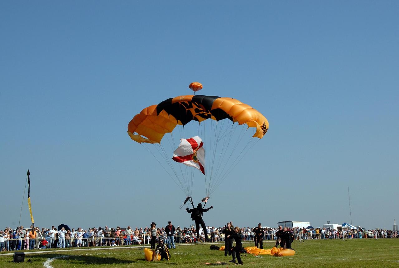 KENNEDY SPACE CENTER, FLA. --  Members of the U.S. Army Golden Knights demonstrate precision landing as part of the World Space Expo aerial salute at NASA's Kennedy Space Center.  Other aircraft joining in the expo salute include the U.S. Air Force Thunderbirds Demonstration Squadron, the U.S. Navy F-18 Super Hornets, U.S. Air Force F-22 Raptor,  U.S. Air Force F-15 Eagle, P-51 Mustang Heritage Flight, and the U.S. Air Force 920th Rescue Wing, which was responsible for Mercury and Gemini capsule recovery. The World Space Expo held Nov. 1-4 was an event commemorating humanity's first 50 years in space while looking forward to returning people to the moon and exploring beyond. The expo showcased various panels, presentations and educational programs. It also was a part of NASA's 50th anniversary celebrations, highlighting the 45th Anniversary of the Mercury Program celebration featuring original NASA astronauts John Glenn and Scott Carpenter and the Pioneering Women of Aerospace forum featuring Eileen Collins and other prominent female space veterans. The agency was founded Oct. 1, 1958.   Photo credit: NASA/Kim Shiflett