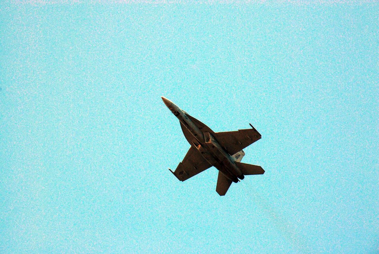 KENNEDY SPACE CENTER, FLA. --  One of the U.S. Navy F-18 Super Hornets flies over NASA's Kennedy Space Center as part of the World Space Expo aerial salute.  Other aircraft joining in the expo salute include the U.S. Air Force Thunderbirds Demonstration Squadron, U.S. Air Force F-22 Raptor,  U.S. Air Force F-15 Eagle, P-51 Mustang Heritage Flight, and the U.S. Air Force 920th Rescue Wing, which was responsible for Mercury and Gemini capsule recovery, and the U.S. Army Golden Knights precision skydiving team. The World Space Expo held Nov. 1-4 was an event commemorating humanity's first 50 years in space while looking forward to returning people to the moon and exploring beyond. The expo showcased various panels, presentations and educational programs. It also was a part of NASA's 50th anniversary celebrations, highlighting the 45th Anniversary of the Mercury Program celebration featuring original NASA astronauts John Glenn and Scott Carpenter and the Pioneering Women of Aerospace forum featuring Eileen Collins and other prominent female space veterans. The agency was founded Oct. 1, 1958.   Photo credit: NASA/Kim Shiflett