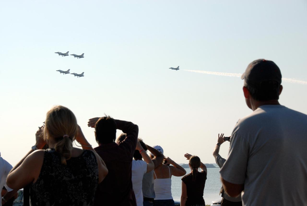 KENNEDY SPACE CENTER, FLA. --  Crowds at NASA's Kennedy Space Center watch the U.S. Air Force Thunderbirds Demonstration Squadron perform during the World Space Expo aerial salute.  Other aircraft joining in the expo salute include the U.S. Navy F-18 Super Hornets, U.S. Air Force F-22 Raptor, U.S. Air Force F-15 Eagle, P-51 Mustang Heritage Flight, the U.S. Air Force 920th Rescue Wing, which was responsible for Mercury and Gemini capsule recovery, and the U.S. Army Golden Knights precision skydivers. The World Space Expo held Nov. 1-4 was an event commemorating humanity's first 50 years in space while looking forward to returning people to the moon and exploring beyond. The expo showcased various panels, presentations and educational programs. It also was a part of NASA's 50th anniversary celebrations, highlighting the 45th Anniversary of the Mercury Program celebration featuring original NASA astronauts John Glenn and Scott Carpenter and the Pioneering Women of Aerospace forum featuring Eileen Collins and other prominent female space veterans. The agency was founded Oct. 1, 1958.   Photo credit: NASA/Kim Shiflett