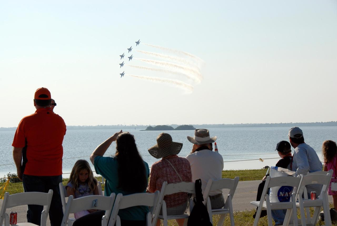KENNEDY SPACE CENTER, FLA. --  Crowds at NASA's Kennedy Space Center watch the U.S. Air Force Thunderbirds Demonstration Squadron perform during the World Space Expo aerial salute.  Other aircraft joining in the expo salute include the U.S. Navy F-18 Super Hornets, U.S. Air Force F-22 Raptor,  U.S. Air Force F-15 Eagle, P-51 Mustang Heritage Flight, the U.S. Air Force 920th Rescue Wing, which was responsible for Mercury and Gemini capsule recovery, and the U.S. Army Golden Knights precision skydivers. The World Space Expo held Nov. 1-4 was an event commemorating humanity's first 50 years in space while looking forward to returning people to the moon and exploring beyond. The expo showcased various panels, presentations and educational programs. It also was a part of NASA's 50th anniversary celebrations, highlighting the 45th Anniversary of the Mercury Program celebration featuring original NASA astronauts John Glenn and Scott Carpenter and the Pioneering Women of Aerospace forum featuring Eileen Collins and other prominent female space veterans. The agency was founded Oct. 1, 1958.   Photo credit: NASA/Kim Shiflett