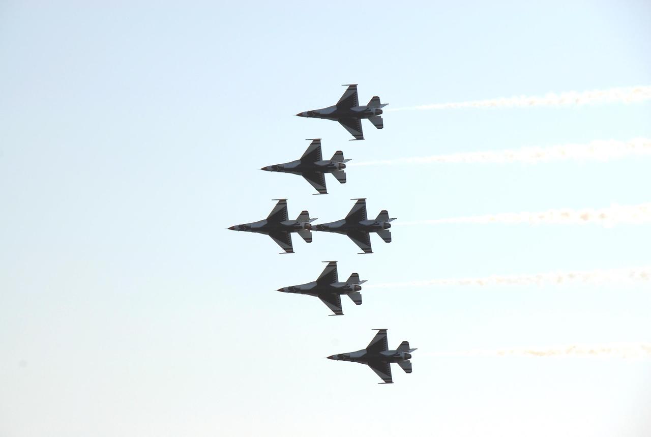 KENNEDY SPACE CENTER, FLA. --  The U.S. Air Force Thunderbirds Demonstration Squadron fly in close formation during the World Space Expo aerial salute.  Other aircraft joining in the expo salute include the U.S. Navy F-18 Super Hornets, U.S. Air Force F-22 Raptor, U.S. Air Force F-15 Eagle, P-51 Mustang Heritage Flight, the U.S. Air Force 920th Rescue Wing, which was responsible for Mercury and Gemini capsule recovery, and the U.S. Army Golden Knights precision skydivers. The World Space Expo held Nov. 1-4 was an event commemorating humanity's first 50 years in space while looking forward to returning people to the moon and exploring beyond. The expo showcased various panels, presentations and educational programs. It also was a part of NASA's 50th anniversary celebrations, highlighting the 45th Anniversary of the Mercury Program celebration featuring original NASA astronauts John Glenn and Scott Carpenter and the Pioneering Women of Aerospace forum featuring Eileen Collins and other prominent female space veterans. The agency was founded Oct. 1, 1958.   Photo credit: NASA/Kim Shiflett