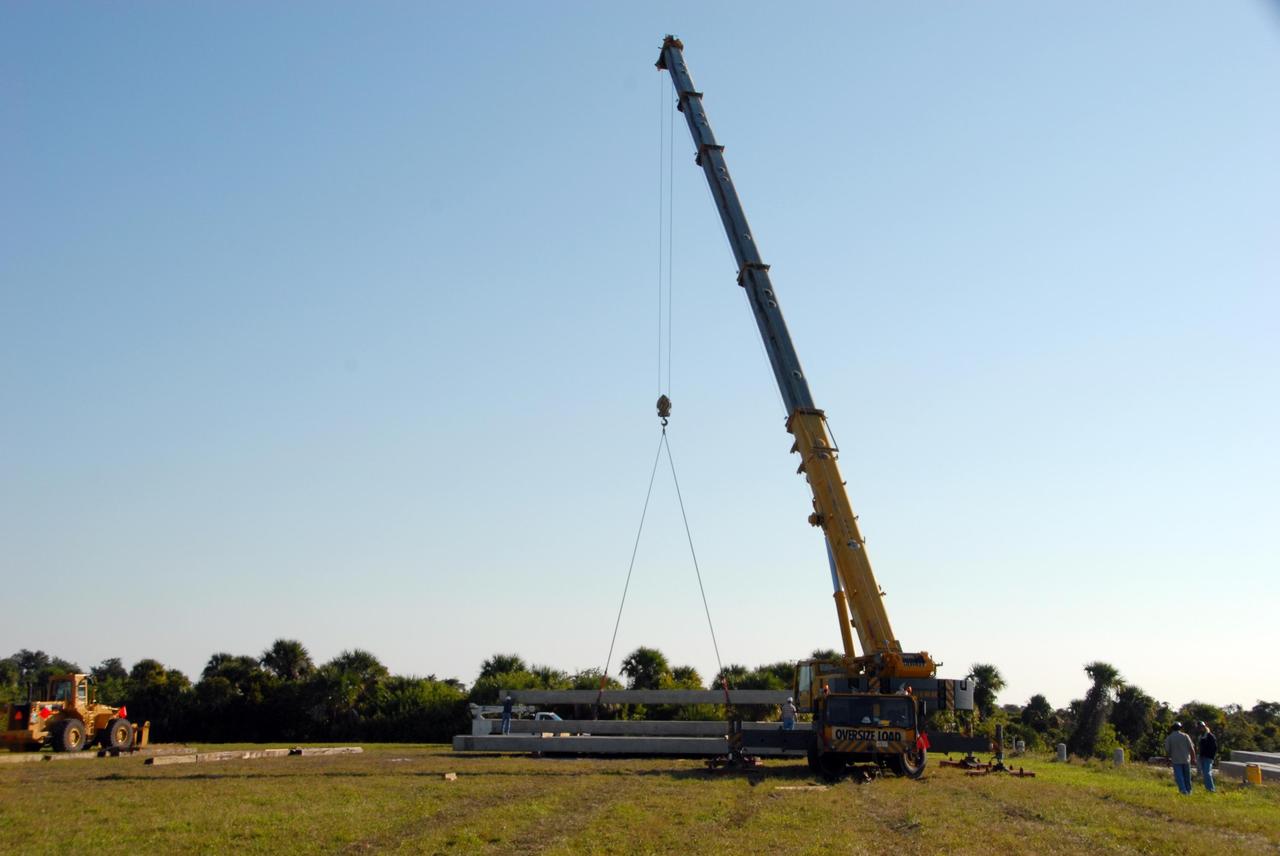 KENNEDY SPACE CENTER, FLA. -- In the Launch Complex 39 Area turn basin at NASA's Kennedy Space Center, the crane crawler moves pilings it lifted from the barge. The pilings will be used to help construct new lightning towers on Launch Pad 39B for the Constellation Program and Ares/Orion launches. Pad B will be the site of the first Ares vehicle launch, including Ares I-X which is scheduled for April 2009. Photo credit: NASA/George Shelton