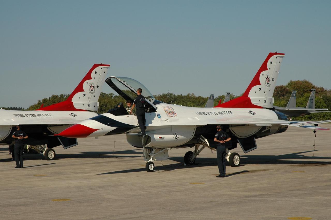 KENNEDY SPACE CENTER, FLA. --   Pilots of the U.S. Air Force Thunderbirds Demonstration Squadron get ready to leave NASA's Kennedy Space Center.  The squadron performed for the World Space Expos' aerial salute along with other aircraft that included the U.S. Navy F-18 Super Hornets, U.S. Air Force F-22 Raptor,  U.S. Air Force F-15 Eagle, P-51 Mustang Heritage Flight, the U.S. Air Force 920th Rescue Wing, which was responsible for Mercury and Gemini capsule recovery, and the U.S. Army Golden Knights precision skydiving team. The World Space Expo held Nov. 1-4 was an event commemorating humanity's first 50 years in space while looking forward to returning people to the moon and exploring beyond. The expo showcased various panels, presentations and educational programs. It also was a part of NASA's 50th anniversary celebrations, highlighting the 45th Anniversary of the Mercury Program celebration featuring original NASA astronauts John Glenn and Scott Carpenter and the Pioneering Women of Aerospace forum featuring Eileen Collins and other prominent female space veterans. The agency was founded Oct. 1, 1958.   Photo credit: NASA/Jim Grossmann