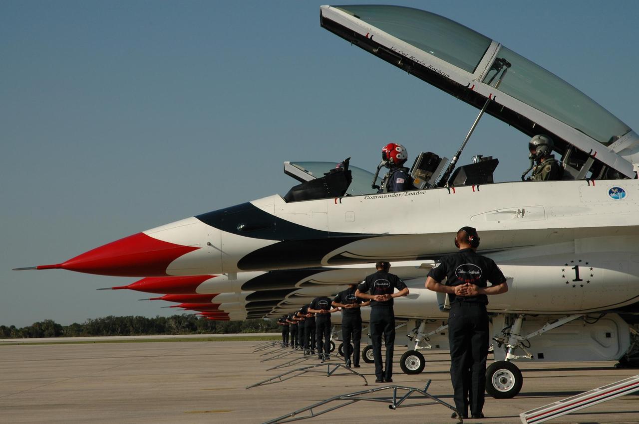 KENNEDY SPACE CENTER, FLA. --  The air crew for the U.S. Air Force Thunderbirds Demonstration Squadron show their precision formation as the pilots get ready to take off from NASA's Kennedy Space Center.  The squadron performed for the World Space Expos' aerial salute along with other aircraft that included the U.S. Navy F-18 Super Hornets, U.S. Air Force F-22 Raptor,  U.S. Air Force F-15 Eagle, P-51 Mustang Heritage Flight, the U.S. Air Force 920th Rescue Wing, which was responsible for Mercury and Gemini capsule recovery, and the U.S. Army Golden Knights precision skydiving team. The World Space Expo held Nov. 1-4 was an event commemorating humanity's first 50 years in space while looking forward to returning people to the moon and exploring beyond. The expo showcased various panels, presentations and educational programs. It also was a part of NASA's 50th anniversary celebrations, highlighting the 45th Anniversary of the Mercury Program celebration featuring original NASA astronauts John Glenn and Scott Carpenter and the Pioneering Women of Aerospace forum featuring Eileen Collins and other prominent female space veterans. The agency was founded Oct. 1, 1958.   Photo credit: NASA/Jim Grossmann