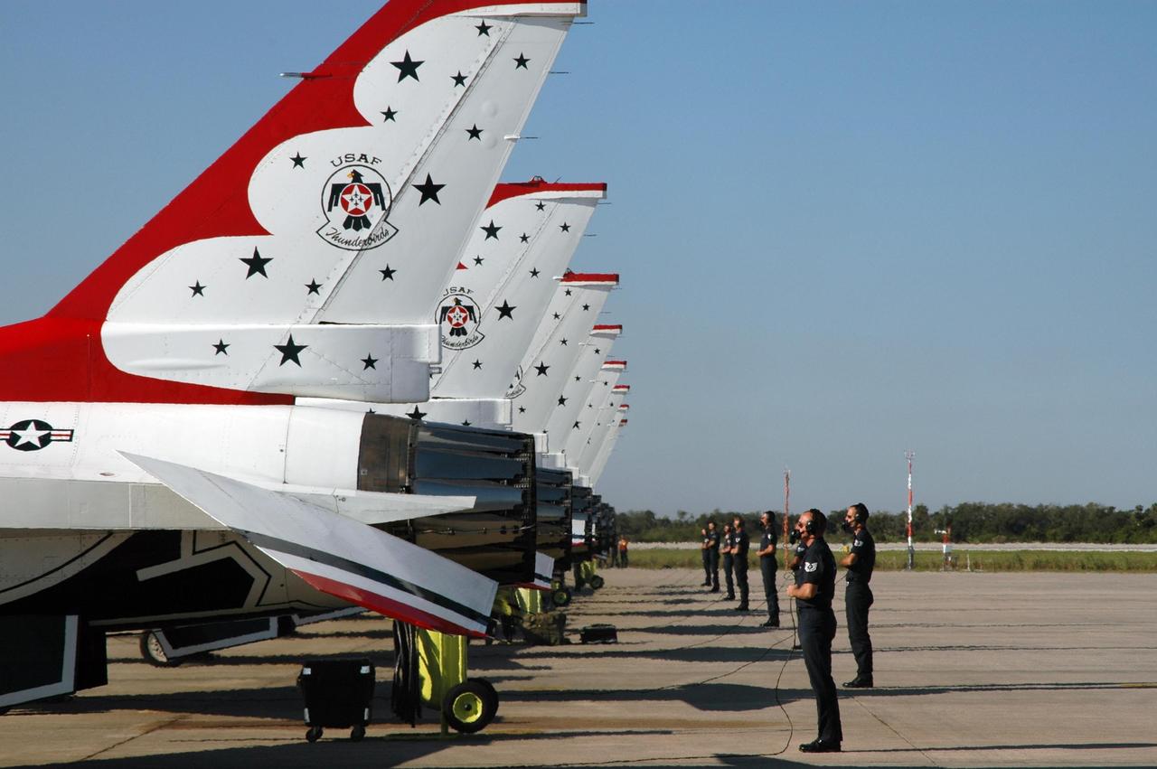 KENNEDY SPACE CENTER, FLA. --  The air crew for the U.S. Air Force Thunderbirds Demonstration Squadron show their precision formation as the planes prepare to take off from NASA's Kennedy Space Center.  The squadron performed for the World Space Expos' aerial salute along with other aircraft that included the U.S. Navy F-18 Super Hornets, U.S. Air Force F-22 Raptor,  U.S. Air Force F-15 Eagle, P-51 Mustang Heritage Flight, the U.S. Air Force 920th Rescue Wing, which was responsible for Mercury and Gemini capsule recovery, and the U.S. Army Golden Knights precision skydiving team. The World Space Expo held Nov. 1-4 was an event commemorating humanity's first 50 years in space while looking forward to returning people to the moon and exploring beyond. The expo showcased various panels, presentations and educational programs. It also was a part of NASA's 50th anniversary celebrations, highlighting the 45th Anniversary of the Mercury Program celebration featuring original NASA astronauts John Glenn and Scott Carpenter and the Pioneering Women of Aerospace forum featuring Eileen Collins and other prominent female space veterans. The agency was founded Oct. 1, 1958.   Photo credit: NASA/Jim Grossmann