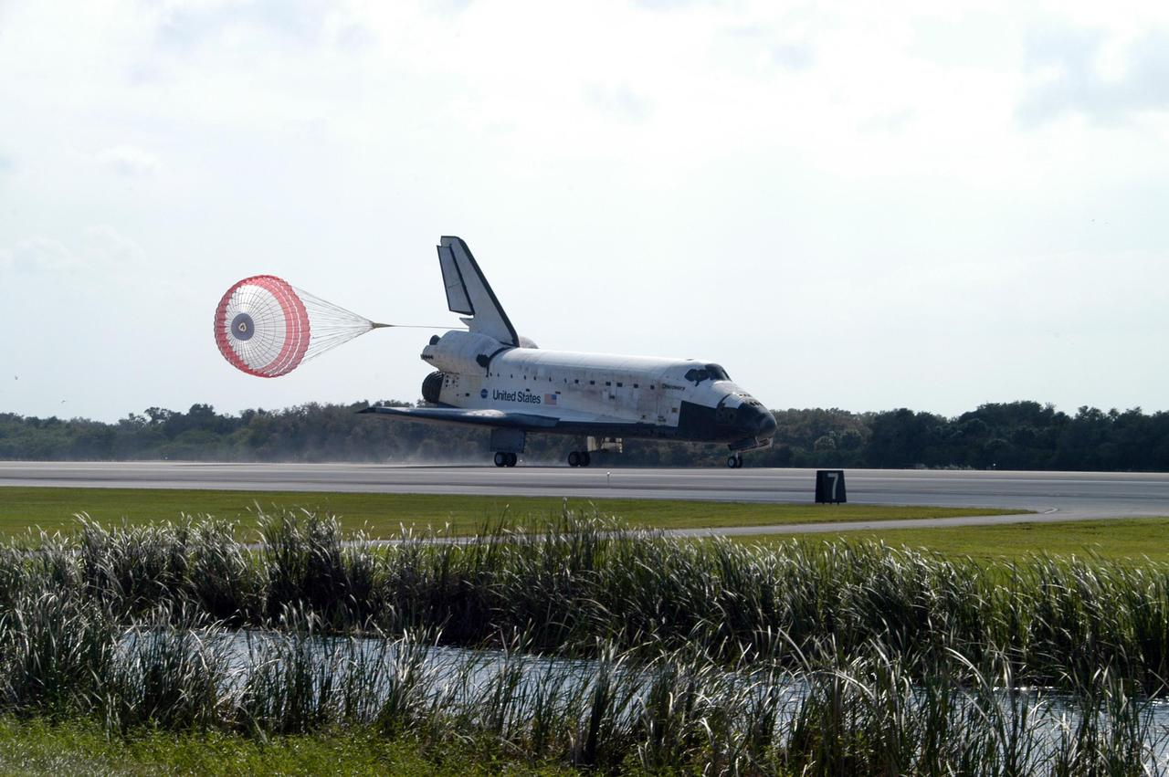 KENNEDY SPACE CENTER, FLA. -- The drag chute deployed behind space shuttle Discovery helps slow its smooth landing on Runway 33 of the Shuttle Landing Facility at NASA's Kennedy Space Center, completing the 15-day mission STS-120.  Main gear touchdown was 1:01:16 p.m.  Wheel stop was at 1:02:07 p.m.  Mission elapsed time was 15 days, 2 hours, 24 minutes and 2 seconds. The STS-120 crew continued the construction of the station with the installation of the Harmony Node 2 module and the relocation of the P6 truss. Photo credit: NASA/George Shelton