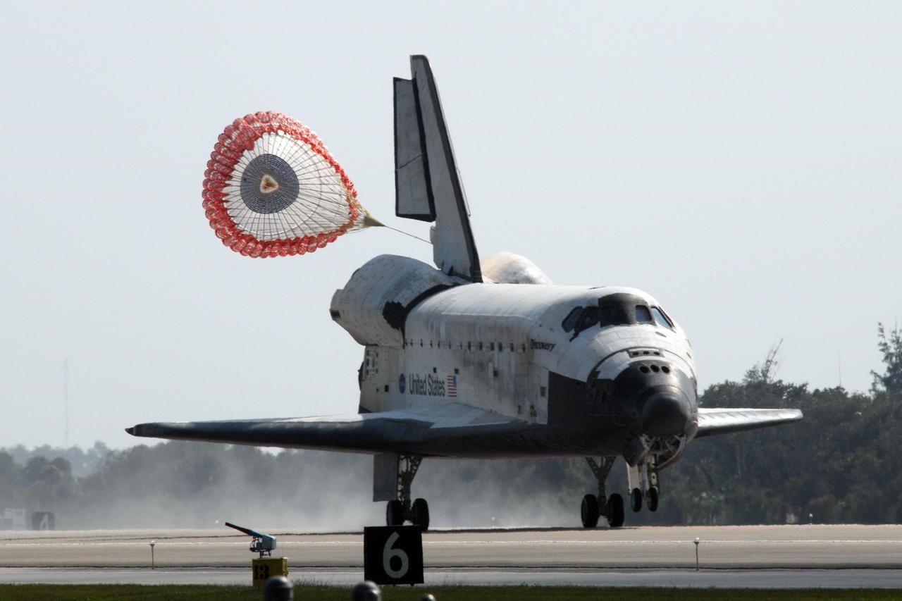 KENNEDY SPACE CENTER, FLA. -- The drag chute deployed behind space shuttle Discovery helps slow its smooth landing on Runway 33 of the Shuttle Landing Facility at NASA's Kennedy Space Center, completing the 15-day mission STS-120.  Main gear touchdown was 1:01:16 p.m.  Wheel stop was at 1:02:07 p.m. Mission elapsed time was 15 days, 2 hours, 24 minutes and 2 seconds.  The STS-120 crew continued the construction of the station with the installation of the Harmony Node 2 module and the relocation of the P6 truss. Photo credit: NASA/George Shelton