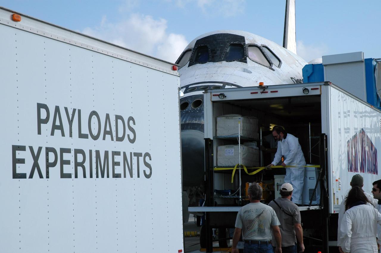 KENNEDY SPACE CENTER, FLA. --  After space shuttle Discovery's landing at NASA's Kennedy Space Center, workers transfer experiments to vehicles.  Discovery completed a 15-day mission to the International Space Station with a smooth landing on Runway 33.  Main gear touchdown was 1:01:16 p.m.  Wheel stop was at 1:02:07 p.m.  Mission elapsed time was 15 days, 2 hours, 24 minutes and 2 seconds.  The crew completed a 15-day mission to the International Space Station with a smooth landing on Runway 33.  Main gear touchdown was 1:01:16 p.m.  Wheel stop was at 1:02:07 p.m.  Mission elapsed time was 15 days, 2 hours, 24 minutes and 2 seconds.  Mission STS-120 continued the construction of the station with the installation of the Harmony Node 2 module and the relocation of the P6 truss. Photo credit: NASA/Jim Grossmann