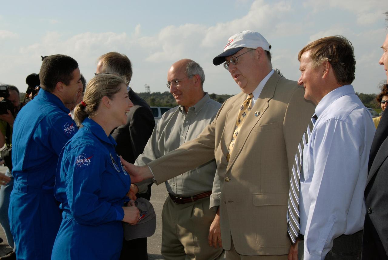 KENNEDY SPACE CENTER, FLA. --  At left, STS-120 Pilot George Zamka and Commander Pamela Melroy are greeted by NASA and Kennedy VIPs after completing their successful mission.  Shuttle Program Manager Wayne Hale talks to Melroy.  On the right is Shuttle Launch Director Mike Leinbach.  Melroy and the Discovery crew completed the 15-day mission STS-120, with an on-time landing at 1:01:16 p.m.  Wheel stop was at 1:02:07 p.m.  Mission elapsed time was 15 days, 2 hours, 24 minutes and 2 seconds. Mission STS-120 continued the construction of the station with the installation of the Harmony Node 2 module and the relocation of the P6 truss. Photo credit: NASA/Kim Shiflett