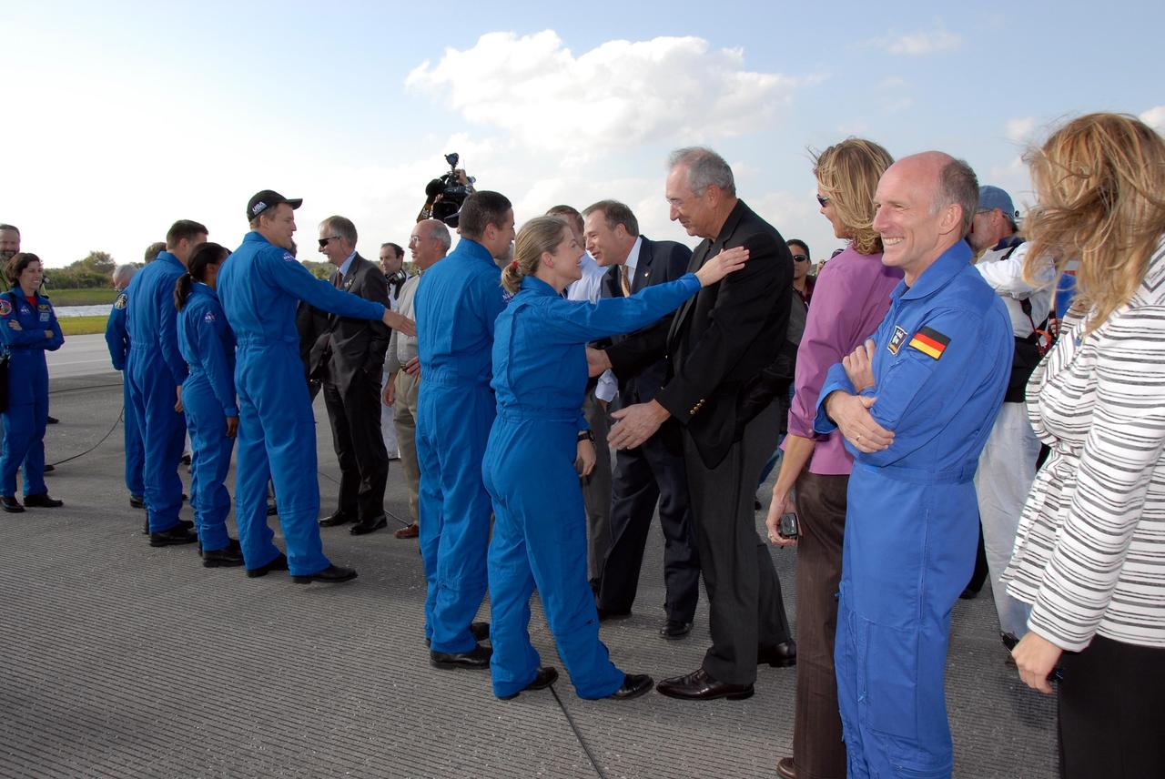 KENNEDY SPACE CENTER, FLA. --  The STS-120 crew members are greeted by NASA and Kennedy VIPs after completing their successful mission.  From left are STS-120 mission specialists Doug Wheelock, Stephanie Wilson and Scott Parazynski, Pilot George Zamka and Commander Pamela Melroy.  The NASA VIPs include NASA Administrator Mike Griffin, Associate Administrator for NASA Space Operations William Gerstenmaier and Shuttle Program Manager Wayne Hale.  The lineup also includes Shuttle Launch Director Mike Leinbach. Melroy and the Discovery crew completed the 15-day mission STS-120, with an on-time landing at 1:01:16 p.m.  Wheel stop was at 1:02:07 p.m.  Mission elapsed time was 15 days, 2 hours, 24 minutes and 2 seconds. Mission elapsed time was 15 days, 2 hours, 24 minutes and 2 seconds. Mission STS-120 continued the construction of the station with the installation of the Harmony Node 2 module and the relocation of the P6 truss. Photo credit: NASA/Kim Shiflett