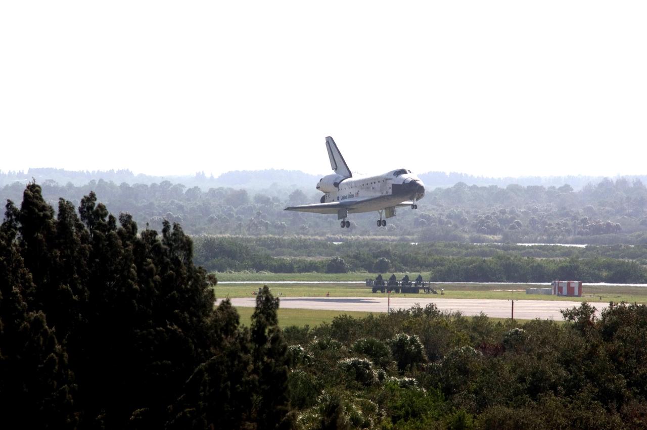 KENNEDY SPACE CENTER, FLA. --   Space shuttle Discovery sinks below the tree line as it approaches landing on Runway 33 of the Shuttle Landing Facility at NASA's Kennedy Space Center, concluding the 15-day mission STS-120.  Commander Pamela Melroy is at the controls, along with Pilot George Zamka.  Main gear touchdown was 1:01:16 p.m.  Wheel stop was at 1:02:07 p.m.  Mission elapsed time was 15 days, 2 hours, 24 minutes and 2 seconds.  Mission STS-120 continued the construction of the station with the installation of the Harmony Node 2 module and the relocation of the P6 truss. Photo credit: NASA/Scott Haun