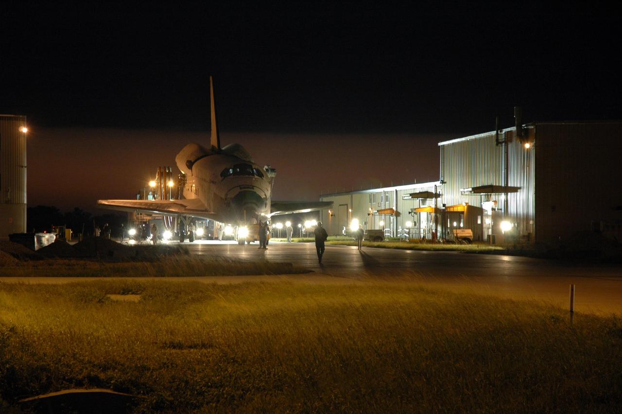 KENNEDY SPACE CENTER, FLA. -- The space shuttle Discovery is towed toward the Orbital Processing Facility, or OPF, where processing Discovery for another flight begins. Towing normally begins within four hours after landing and is completed within six hours unless removal of time-sensitive experiments is required on the runway. In the OPF, turnaround processing procedures on Discovery will include various post-flight deservicing and maintenance functions, which are carried out in parallel with payload removal and the installation of equipment needed for the next mission. Before post-flight deservicing can continue beyond initial safing operations, certain vehicle systems must be mechanically secured and access platforms installed. Discovery completed mission STS-120 with an on-time landing at 1:01 p.m. EST. Photo credit: NASA/Jim Grossmann