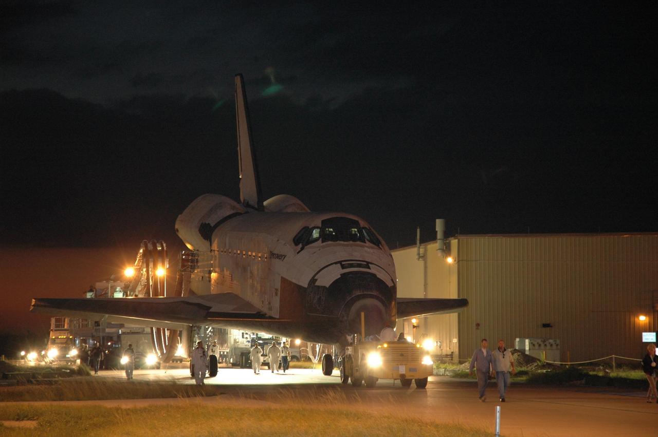 KENNEDY SPACE CENTER, FLA. -- The space shuttle Discovery nears the Orbital Processing Facility, or OPF, where processing Discovery for another flight begins. Towing normally begins within four hours after landing and is completed within six hours unless removal of time-sensitive experiments is required on the runway. In the OPF, turnaround processing procedures on Discovery will include various post-flight deservicing and maintenance functions, which are carried out in parallel with payload removal and the installation of equipment needed for the next mission. Before post-flight deservicing can continue beyond initial safing operations, certain vehicle systems must be mechanically secured and access platforms installed. Discovery completed mission STS-120 with an on-time landing at 1:01 p.m. EST. Photo credit: NASA/Jim Grossmann